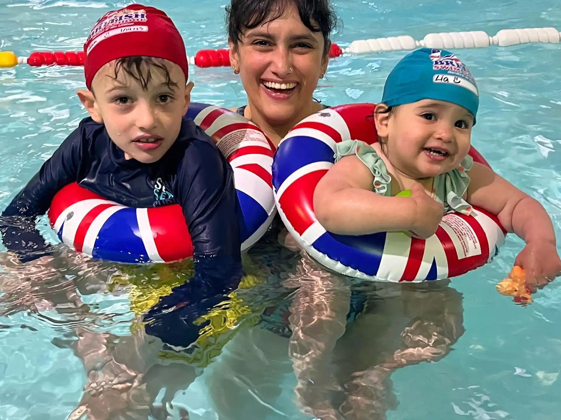 a person and two boys in a pool
