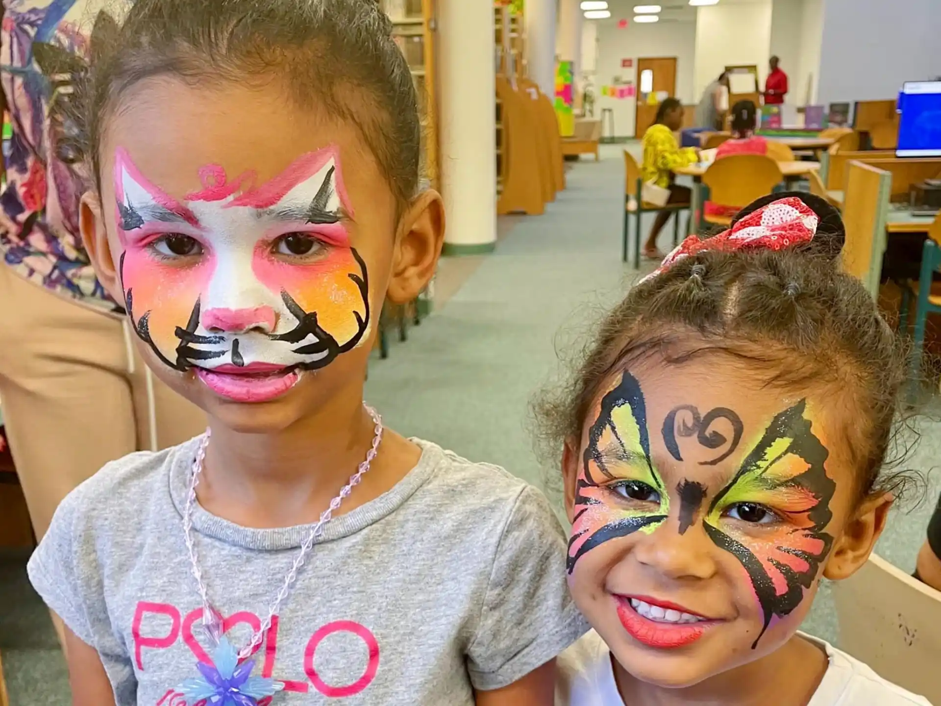 a couple of girls with face paint
