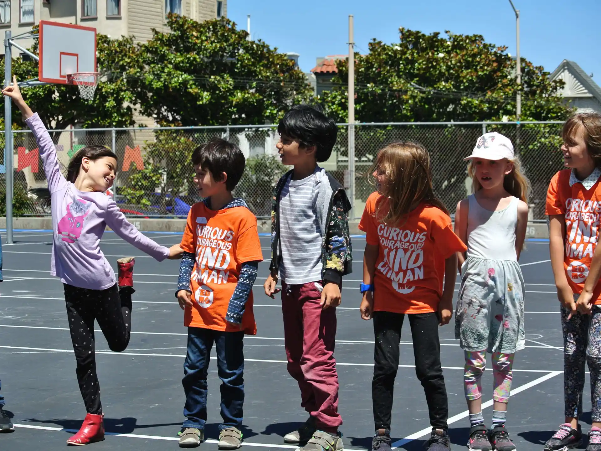 a group of children playing basketball