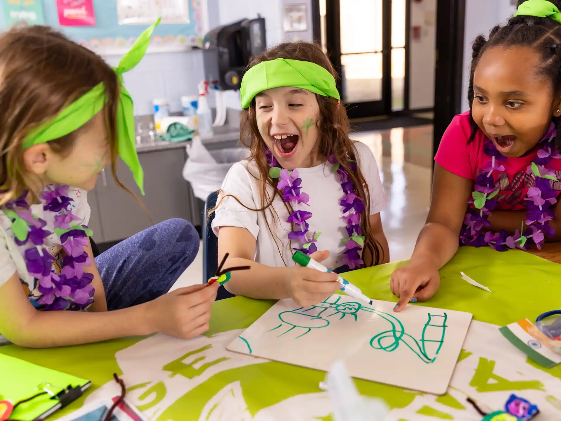 a group of children sitting at a table with a paper
