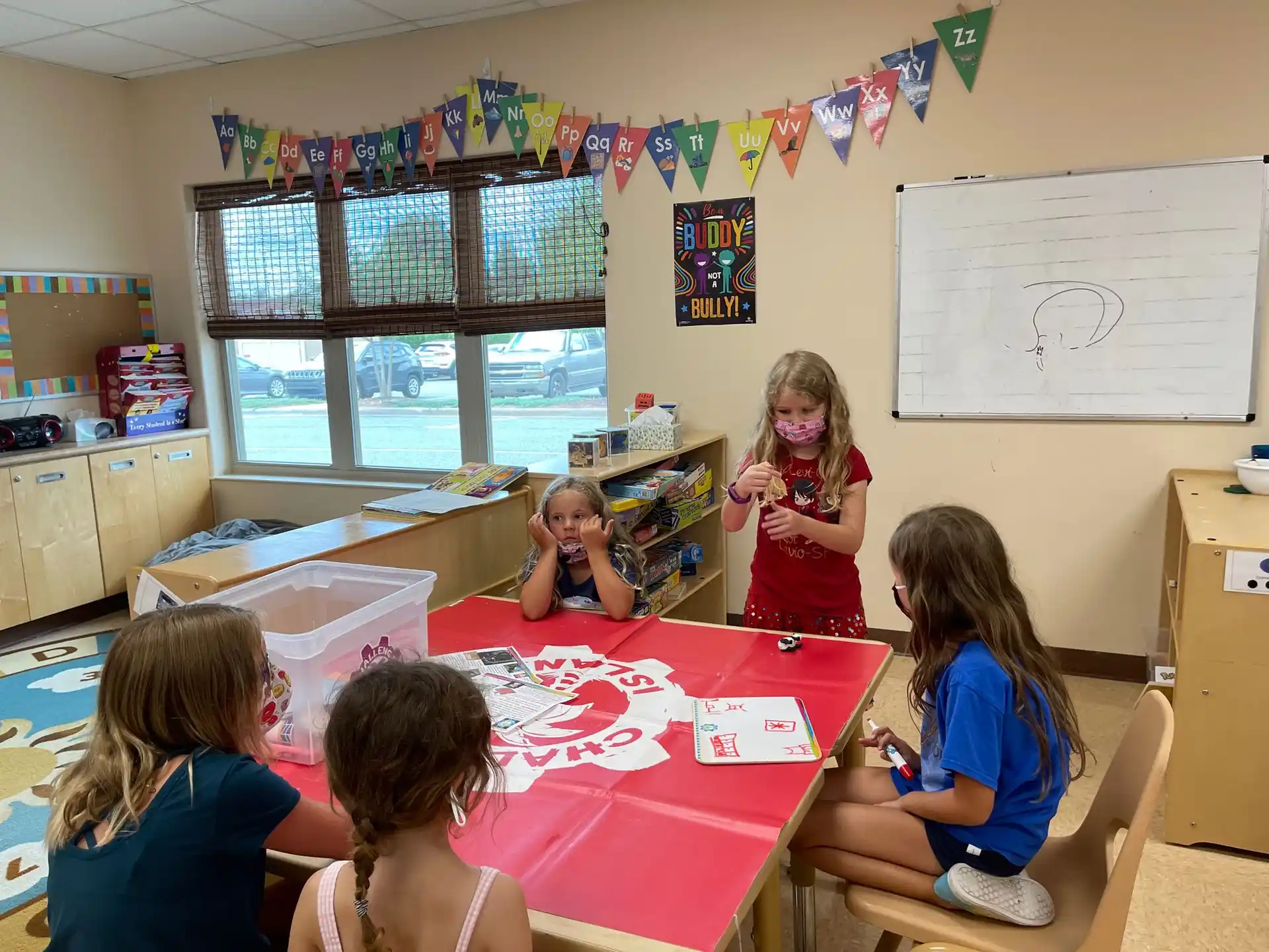 a group of children sitting around a table