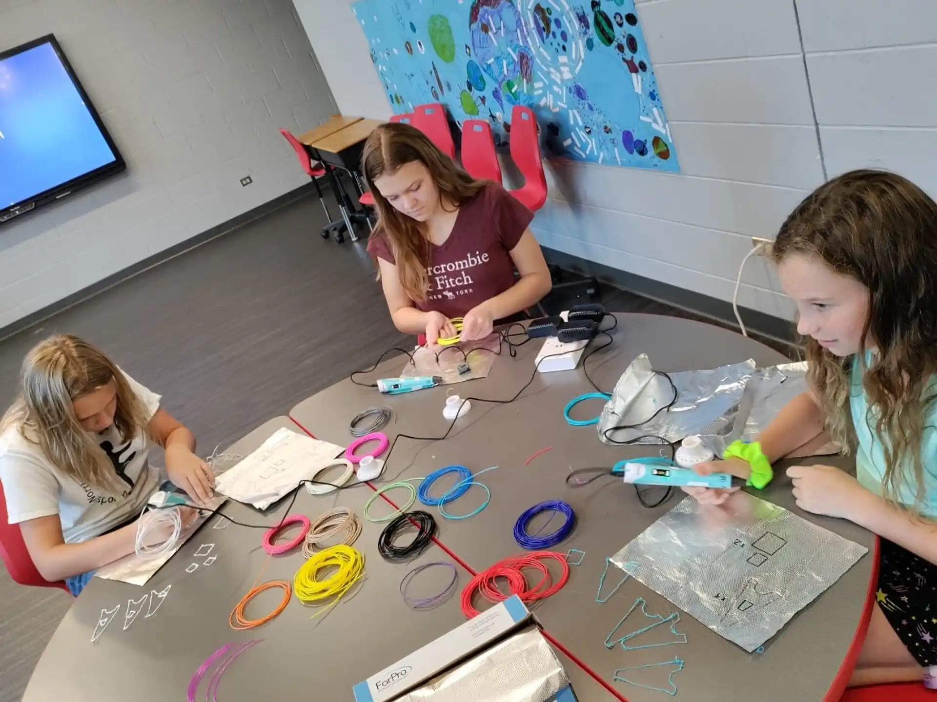 a few young girls working on a project