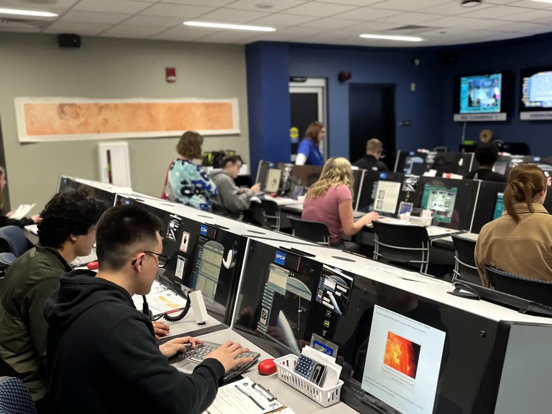 a group of people sitting at computers