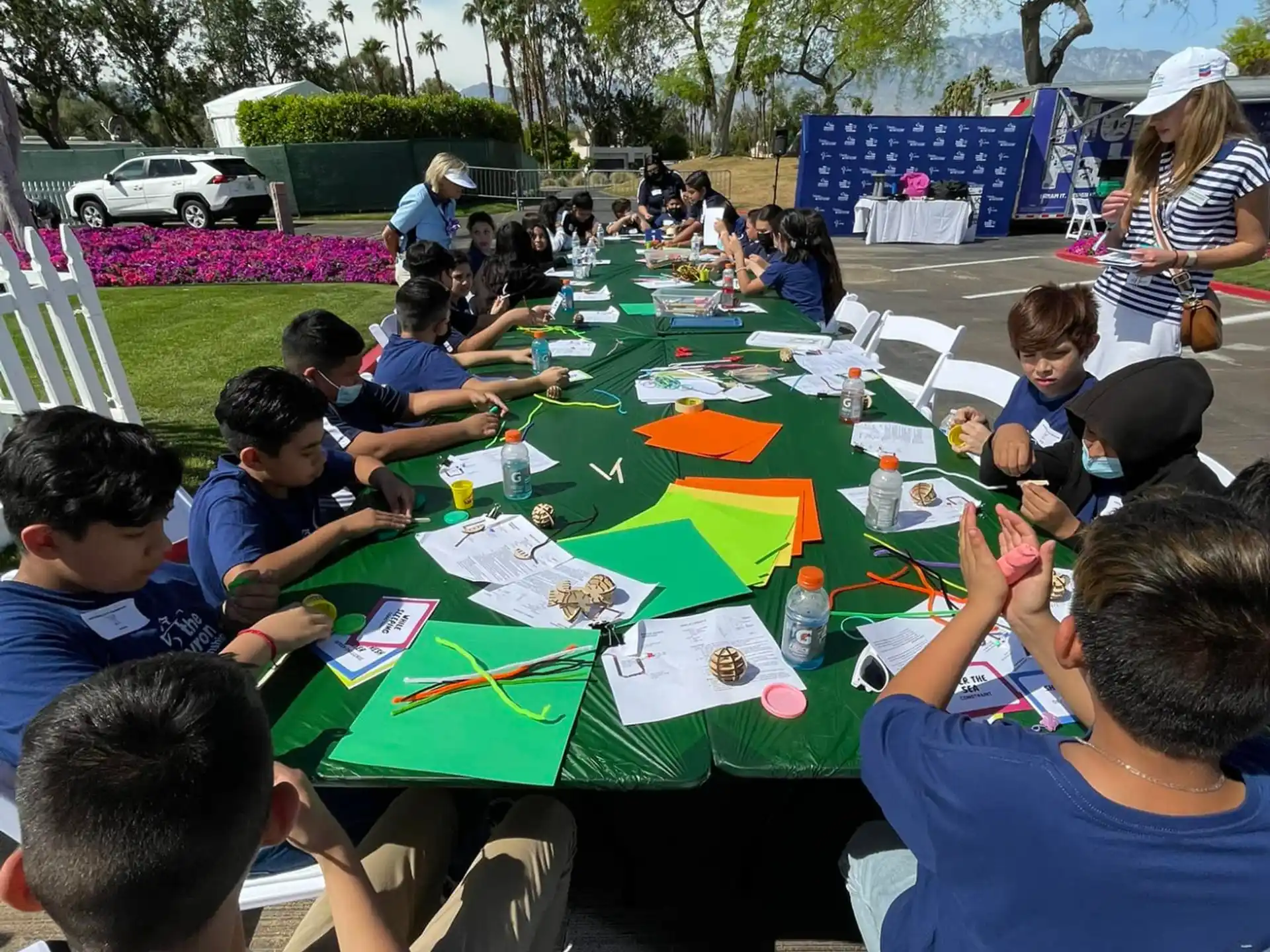 a group of people sitting at a table outside