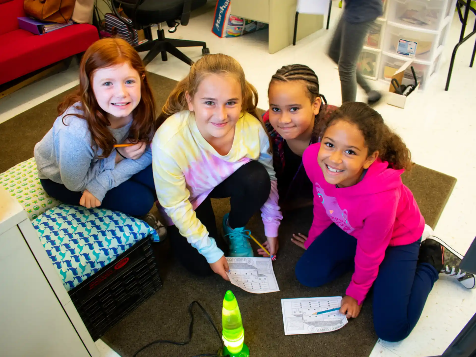 a group of girls sitting on the floor