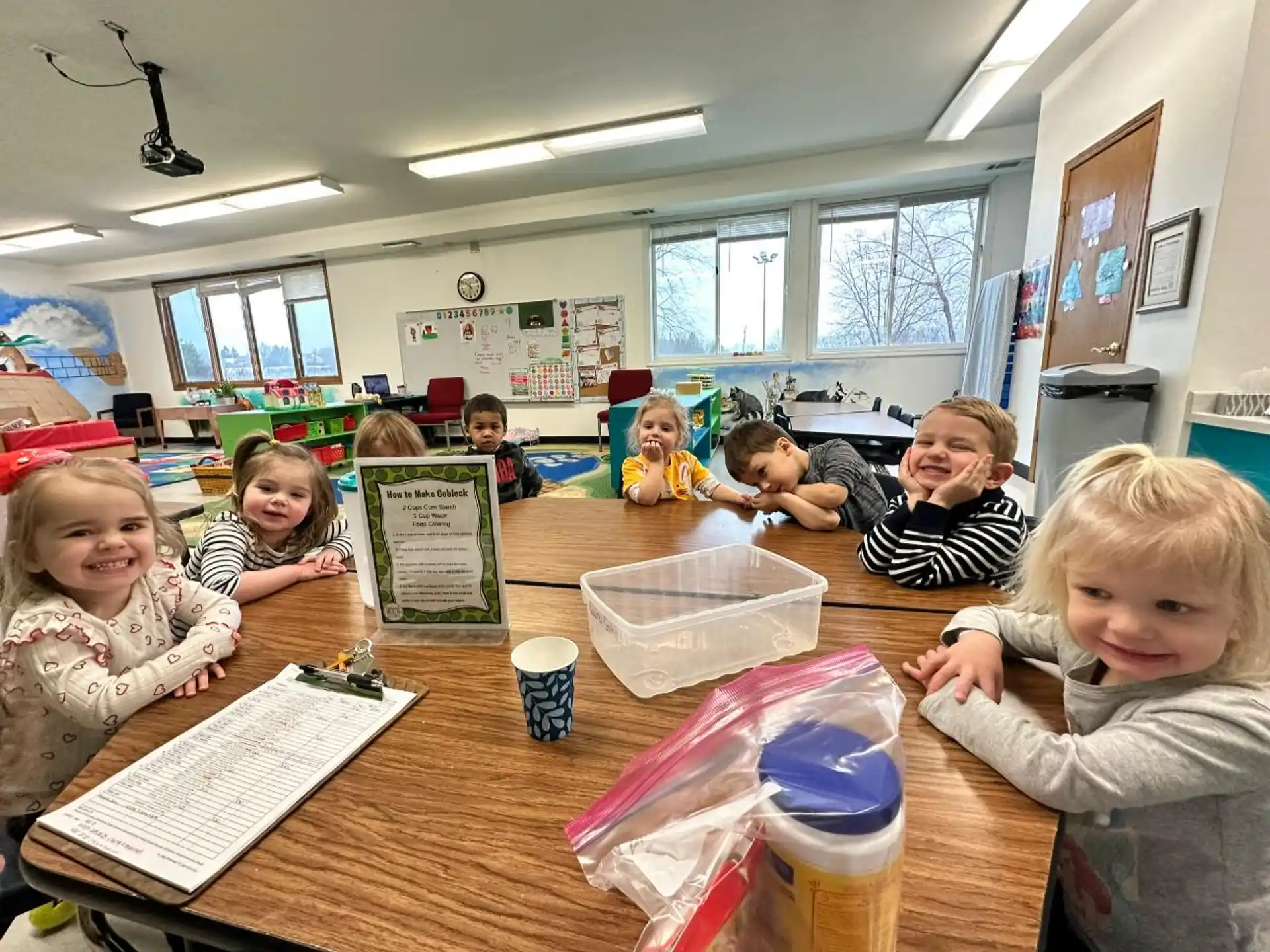 a group of children sitting at a table