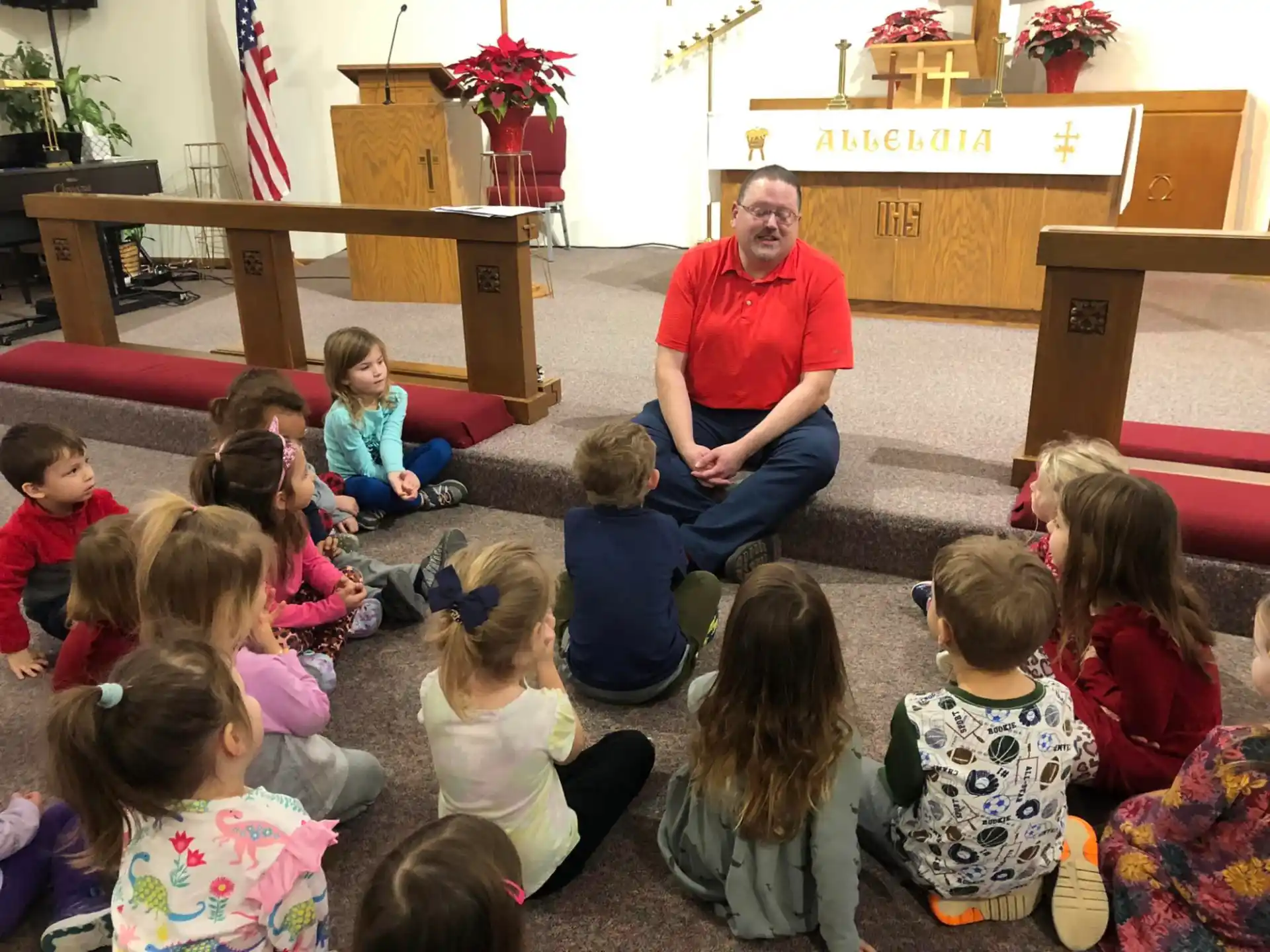 a person sitting in front of a group of children