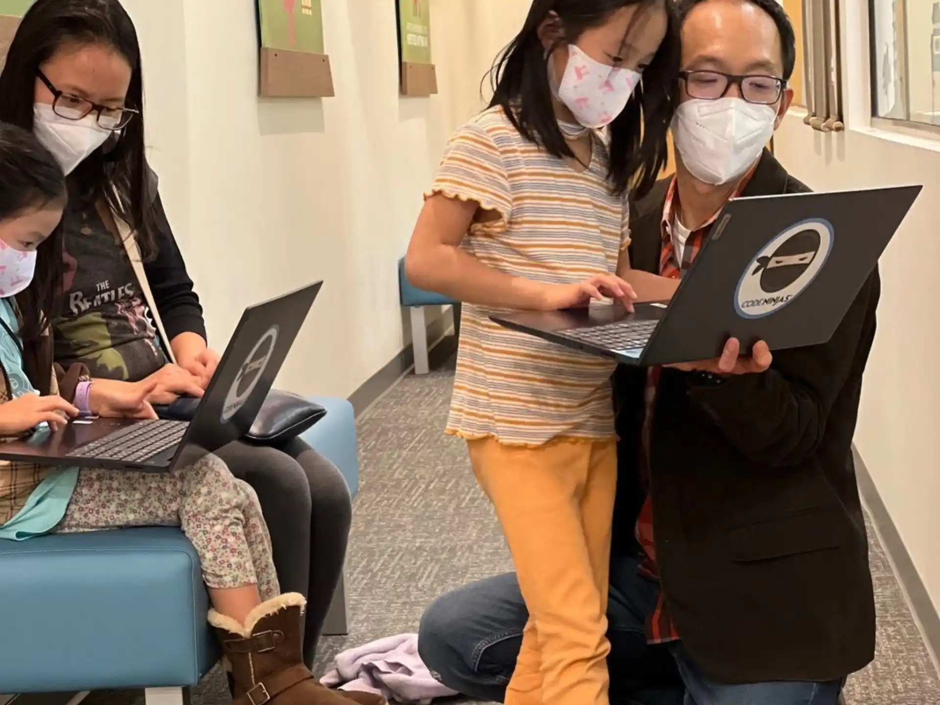 a group of people with laptops