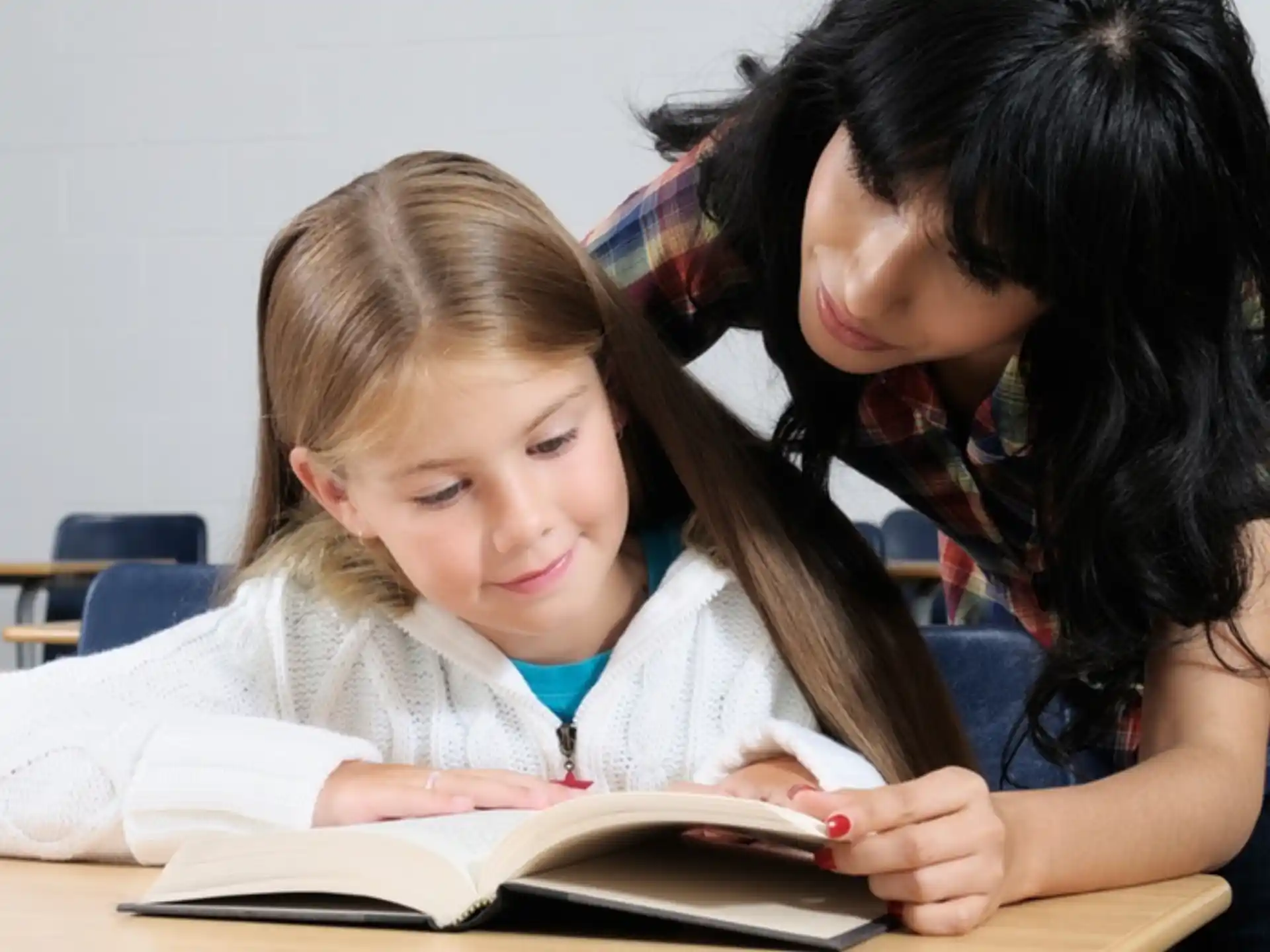 a person and a child reading a book