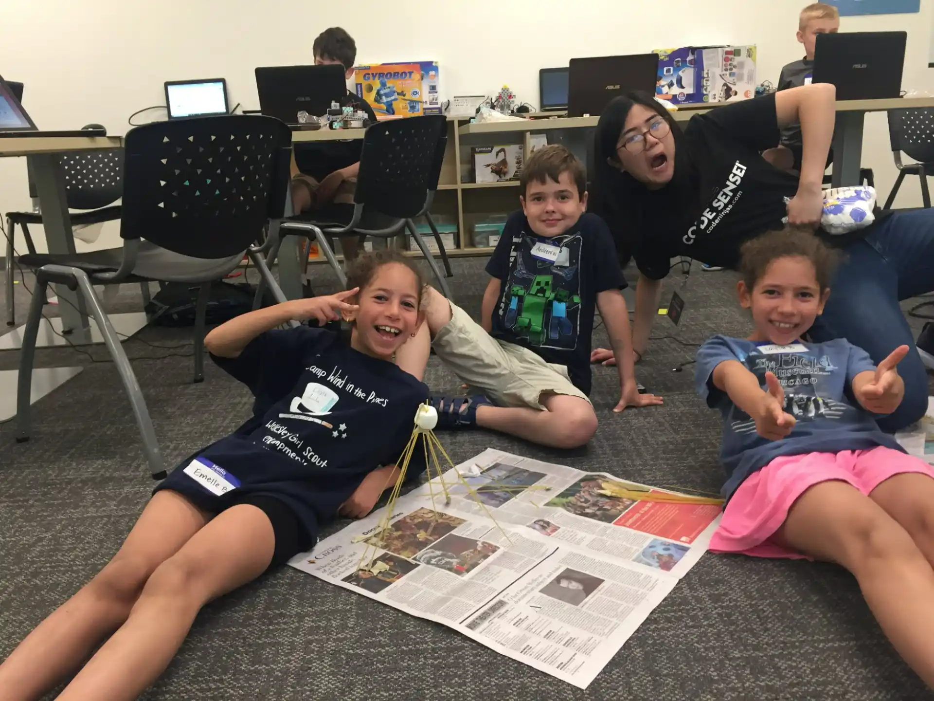 a group of people sitting on the floor and smiling