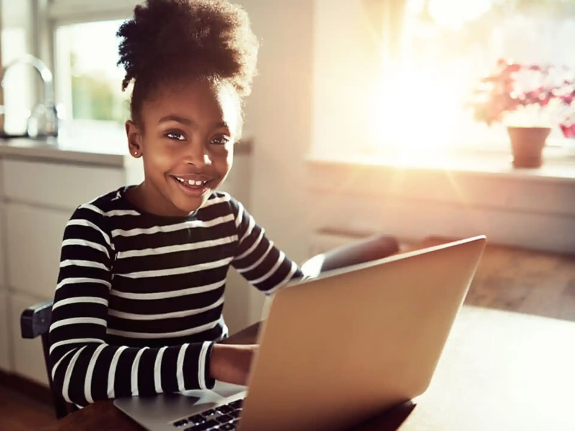 a young boy using a laptop