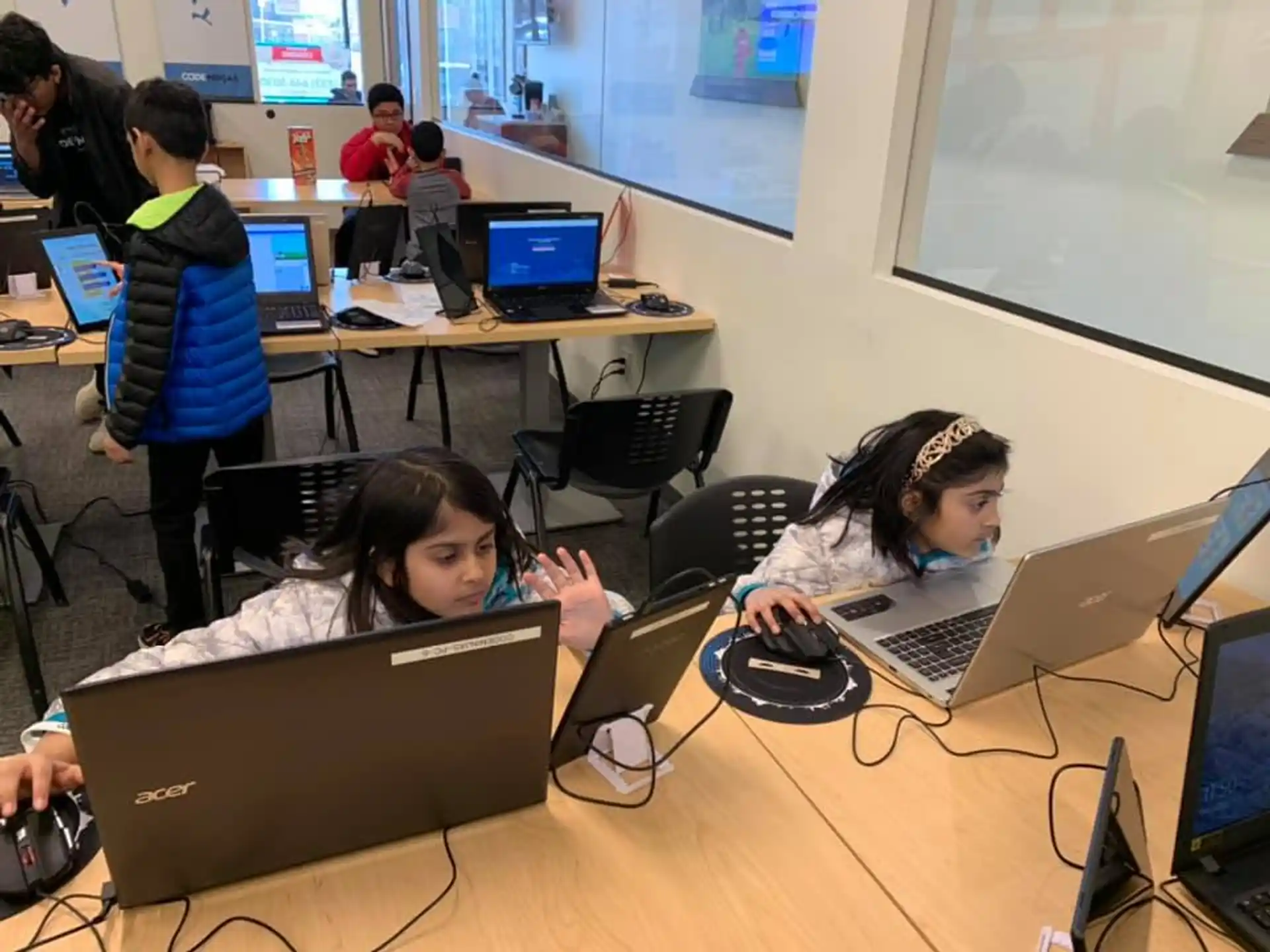 a group of people working on laptops