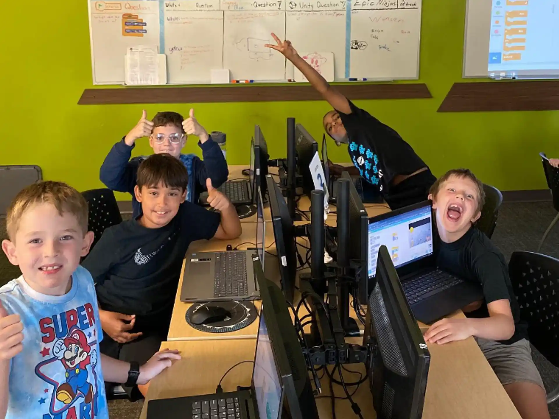 a group of people sitting at computers