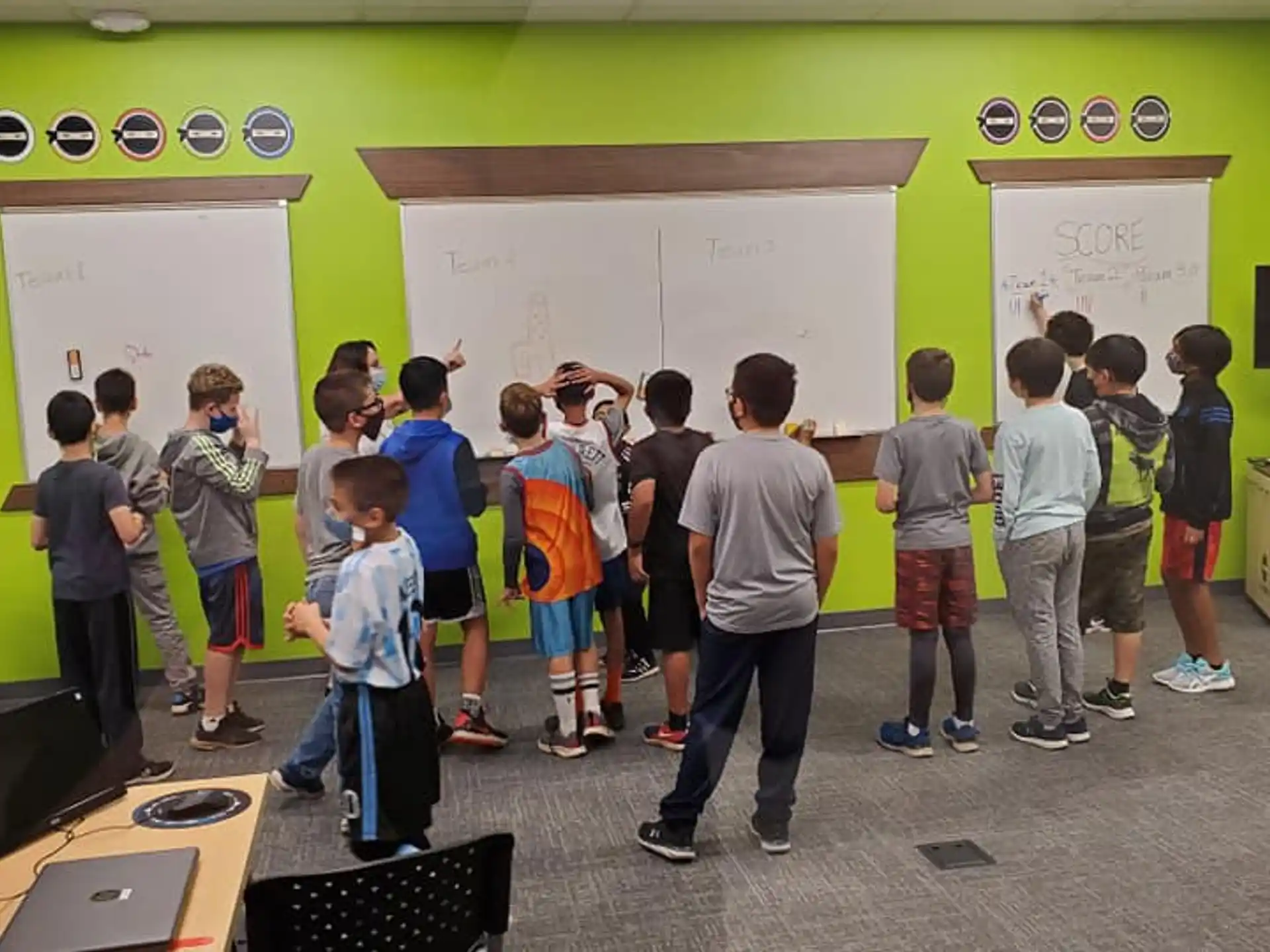 a group of kids standing in a classroom