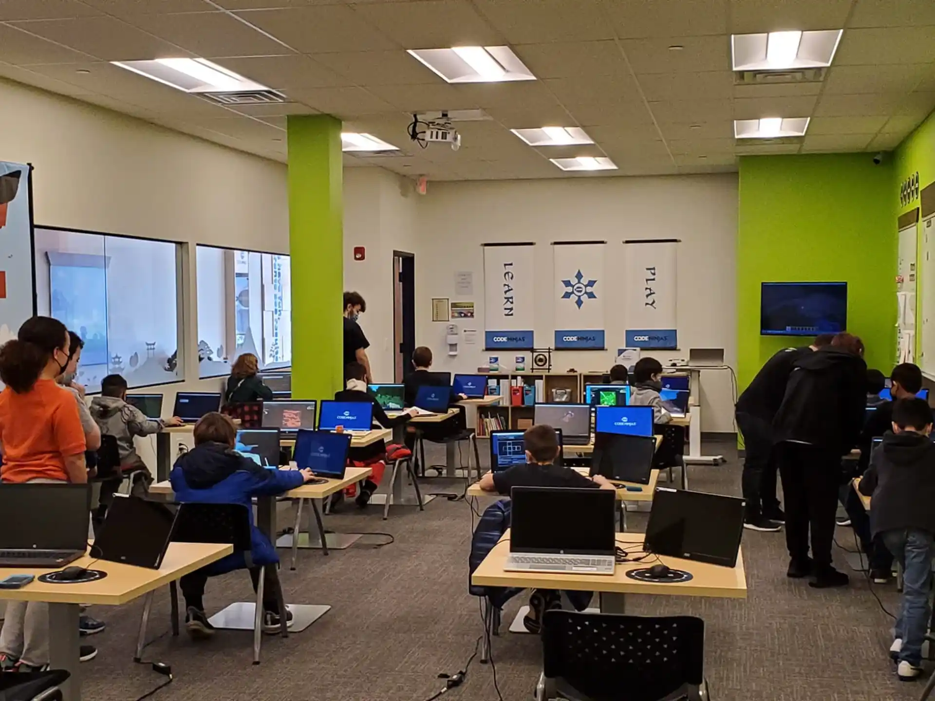 a group of people in a room with computers