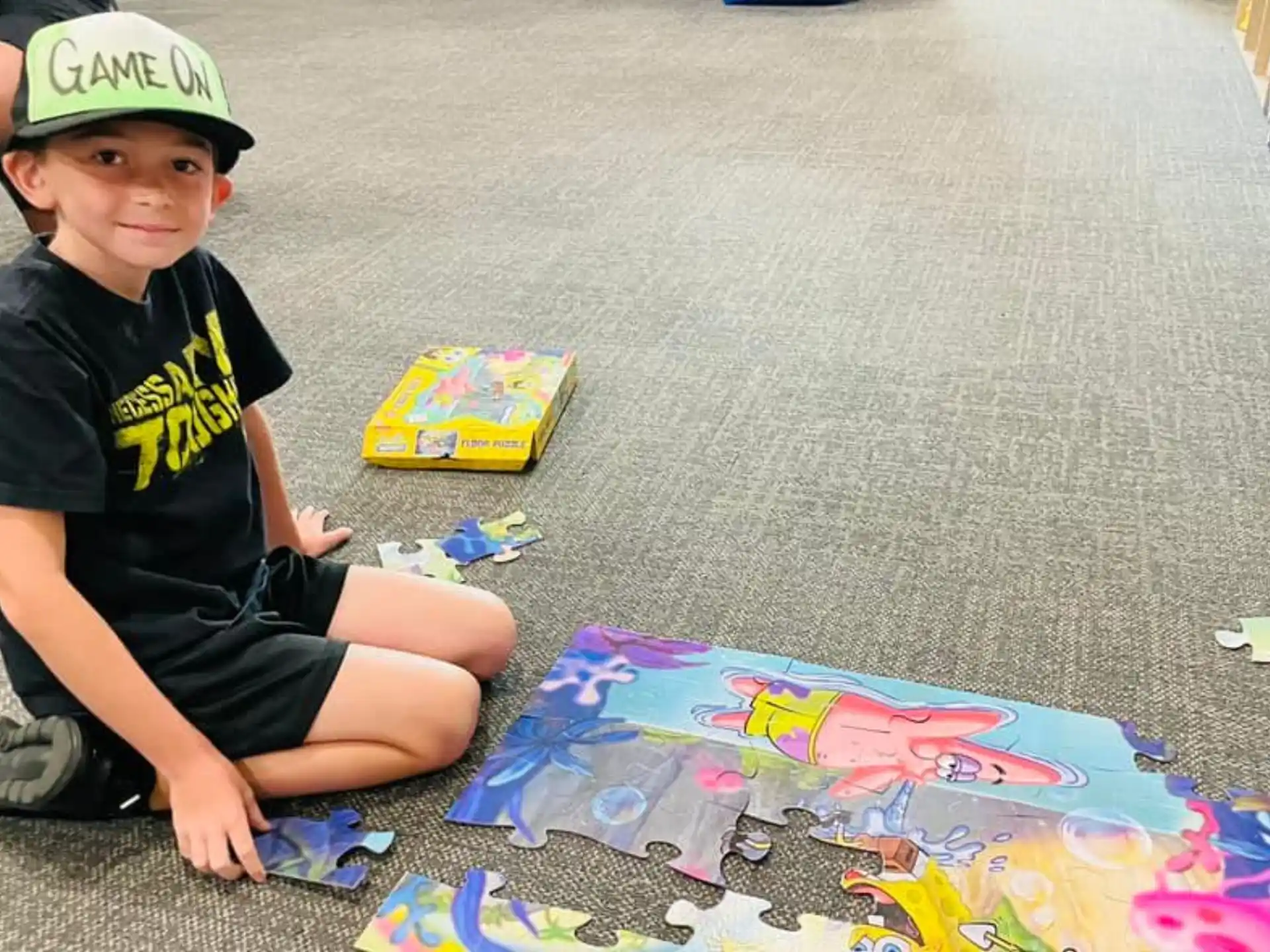 a boy sitting on the floor