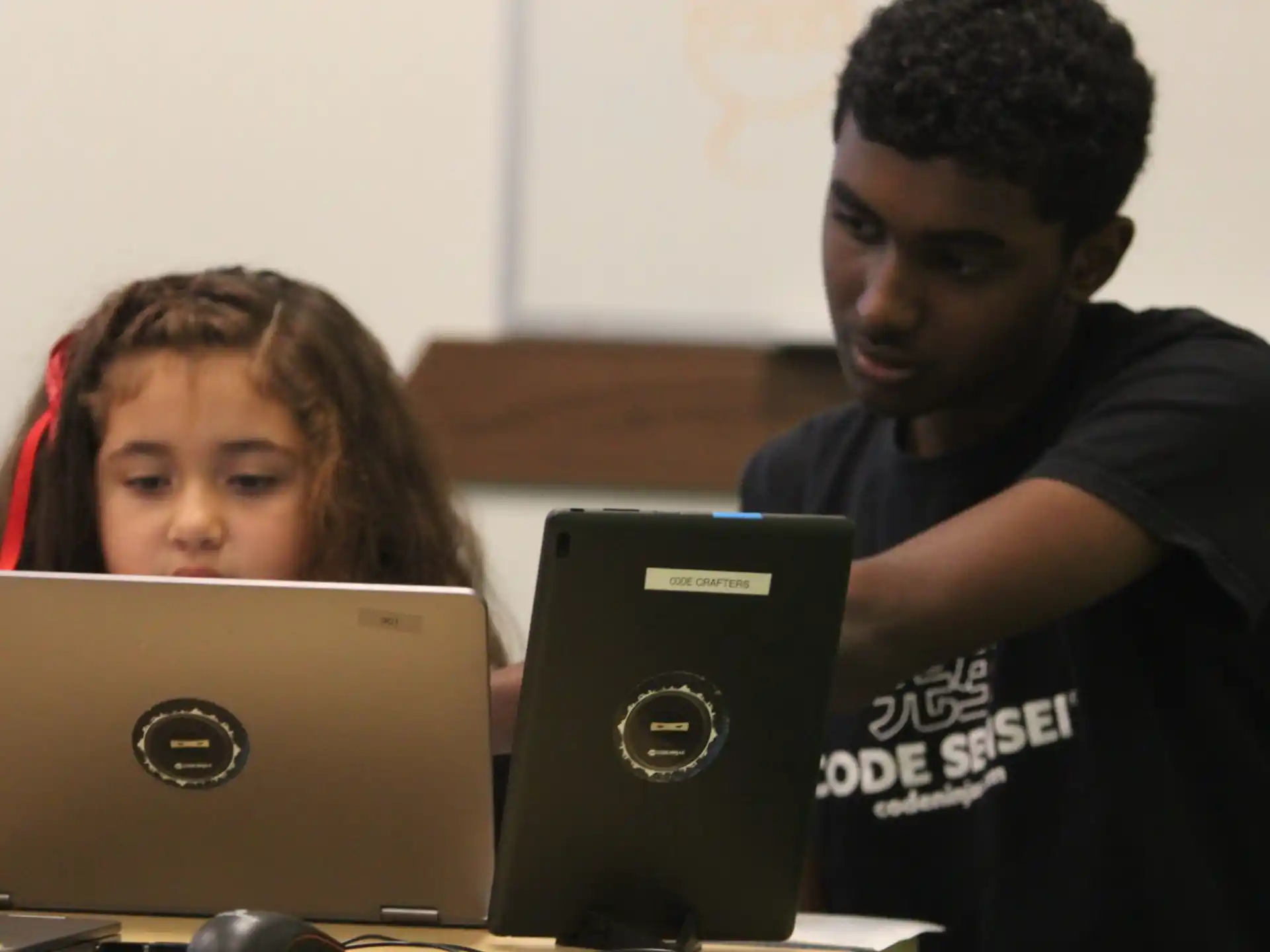 a man and a woman looking at a laptop