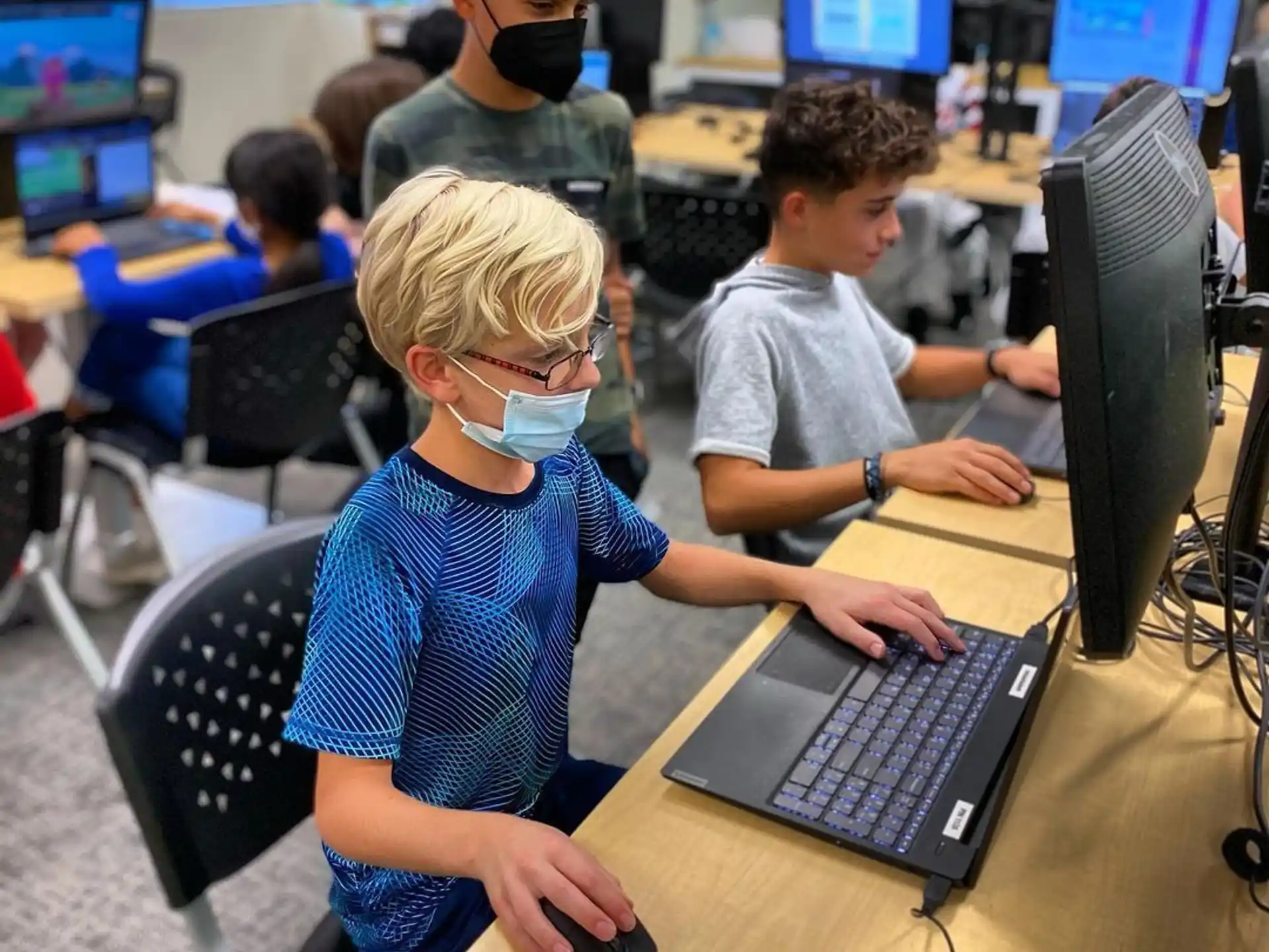 a group of people working on computers