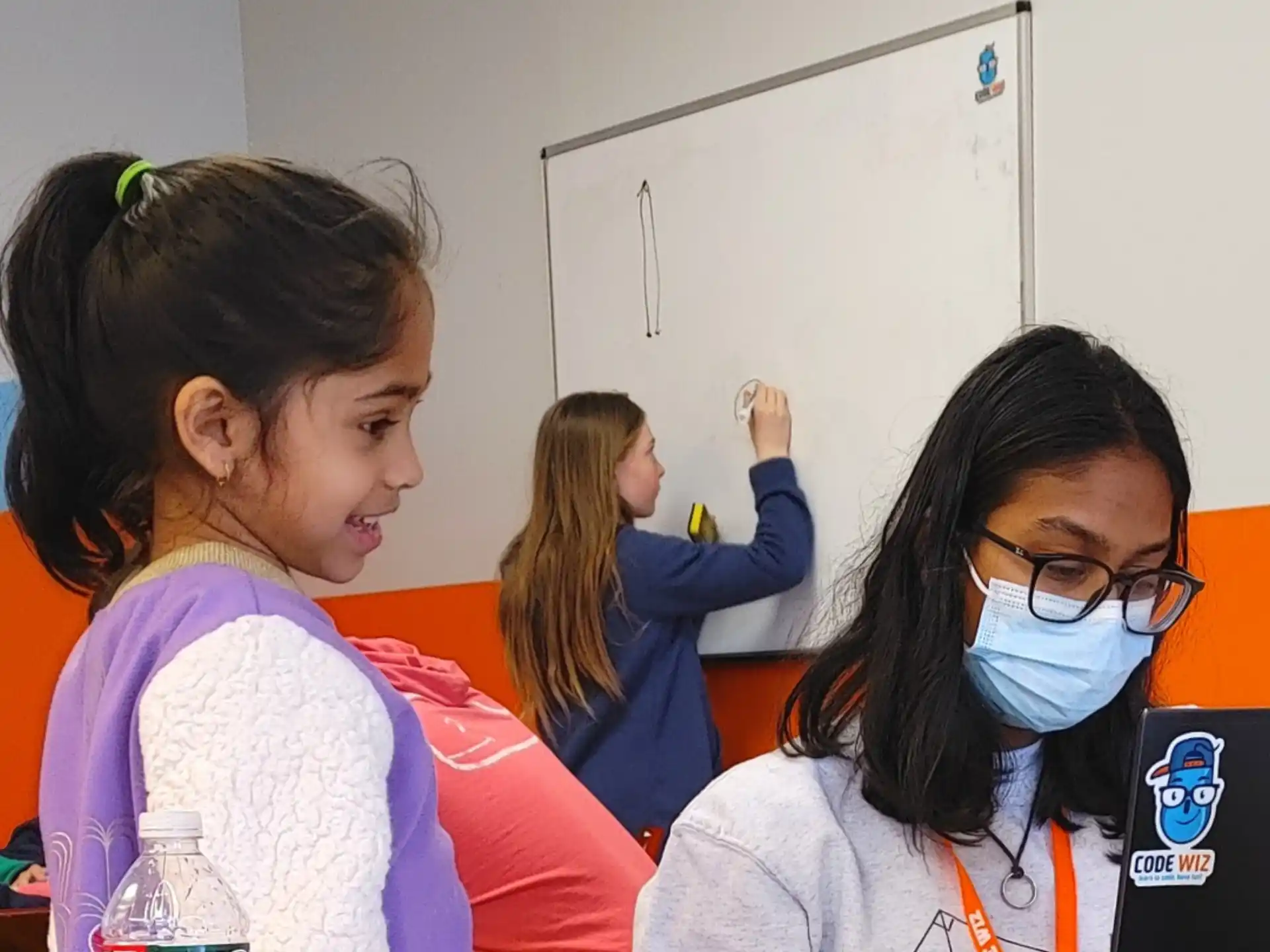 a few young girls in a classroom