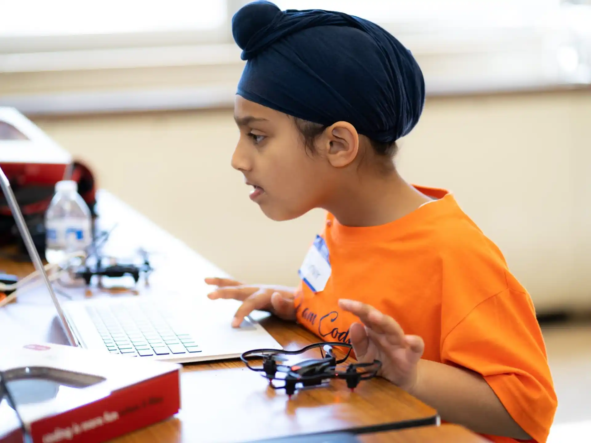a young boy using a laptop