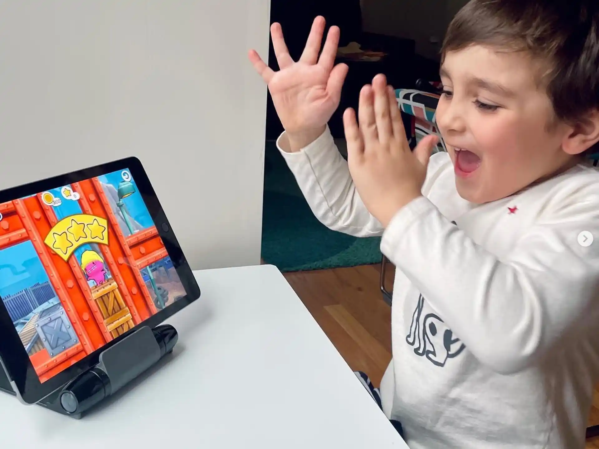 a child pointing at a computer screen