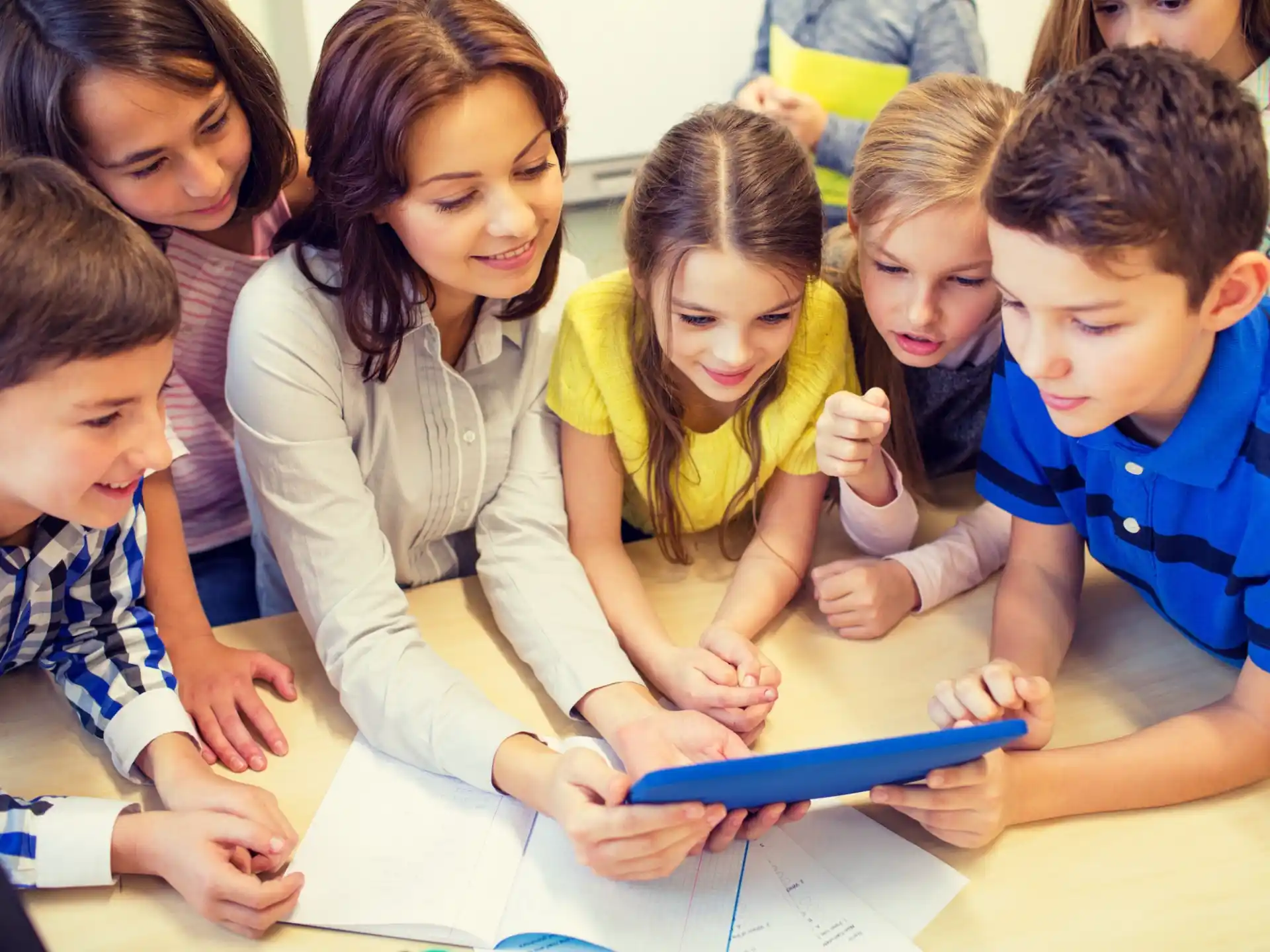 a group of children looking at a paper