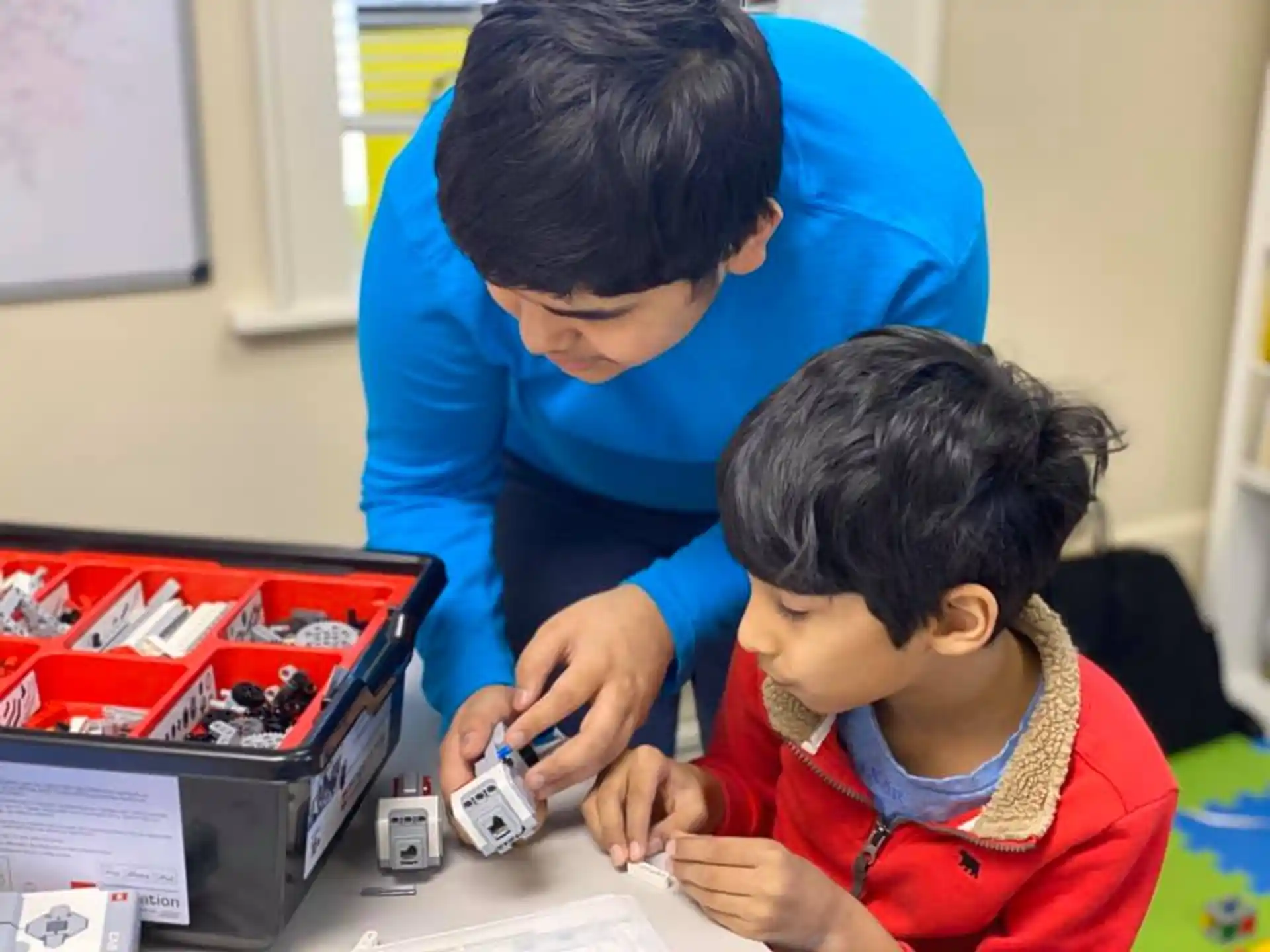 a person and a boy playing with a toy