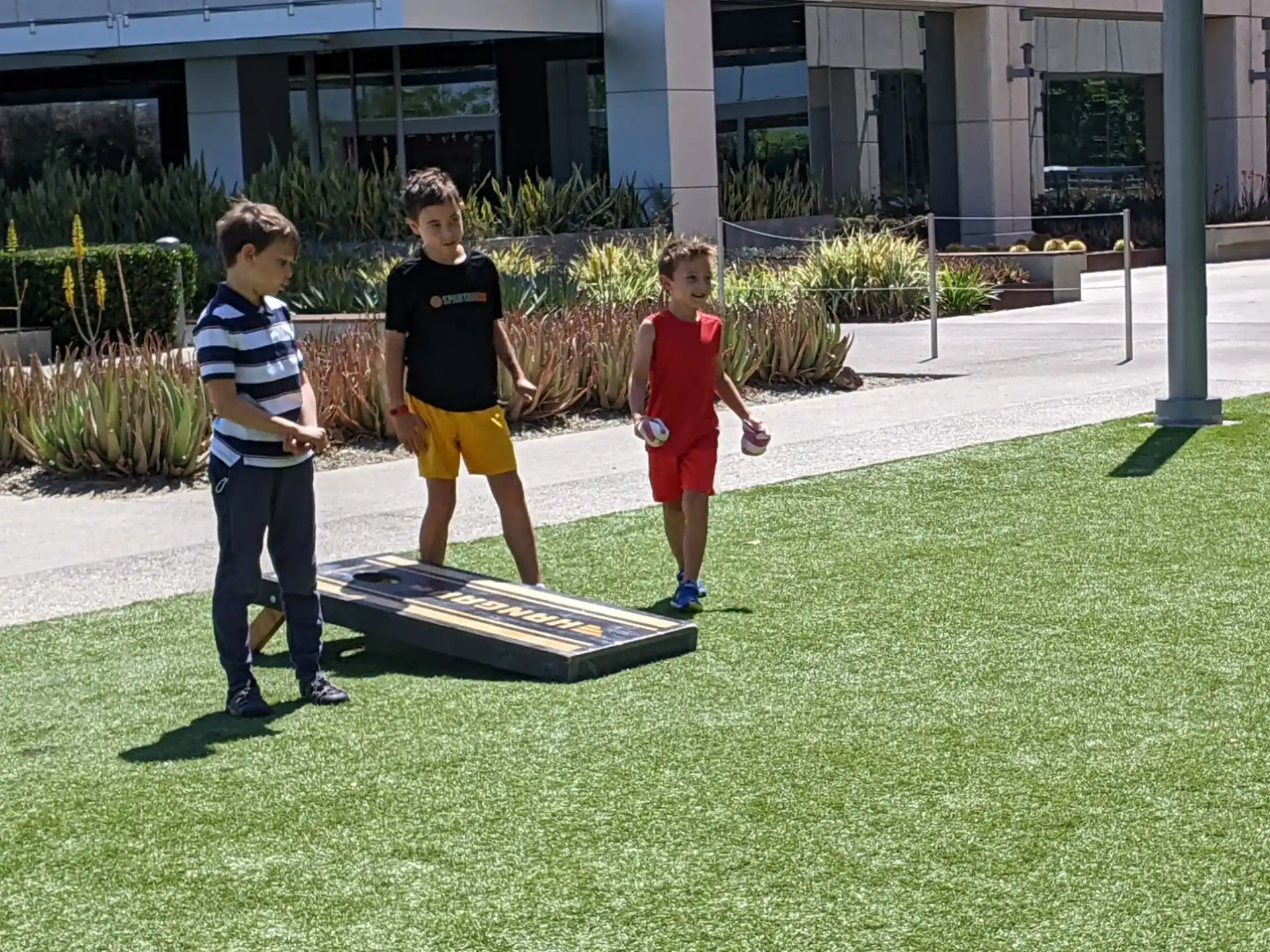 a group of boys playing with a model airplane