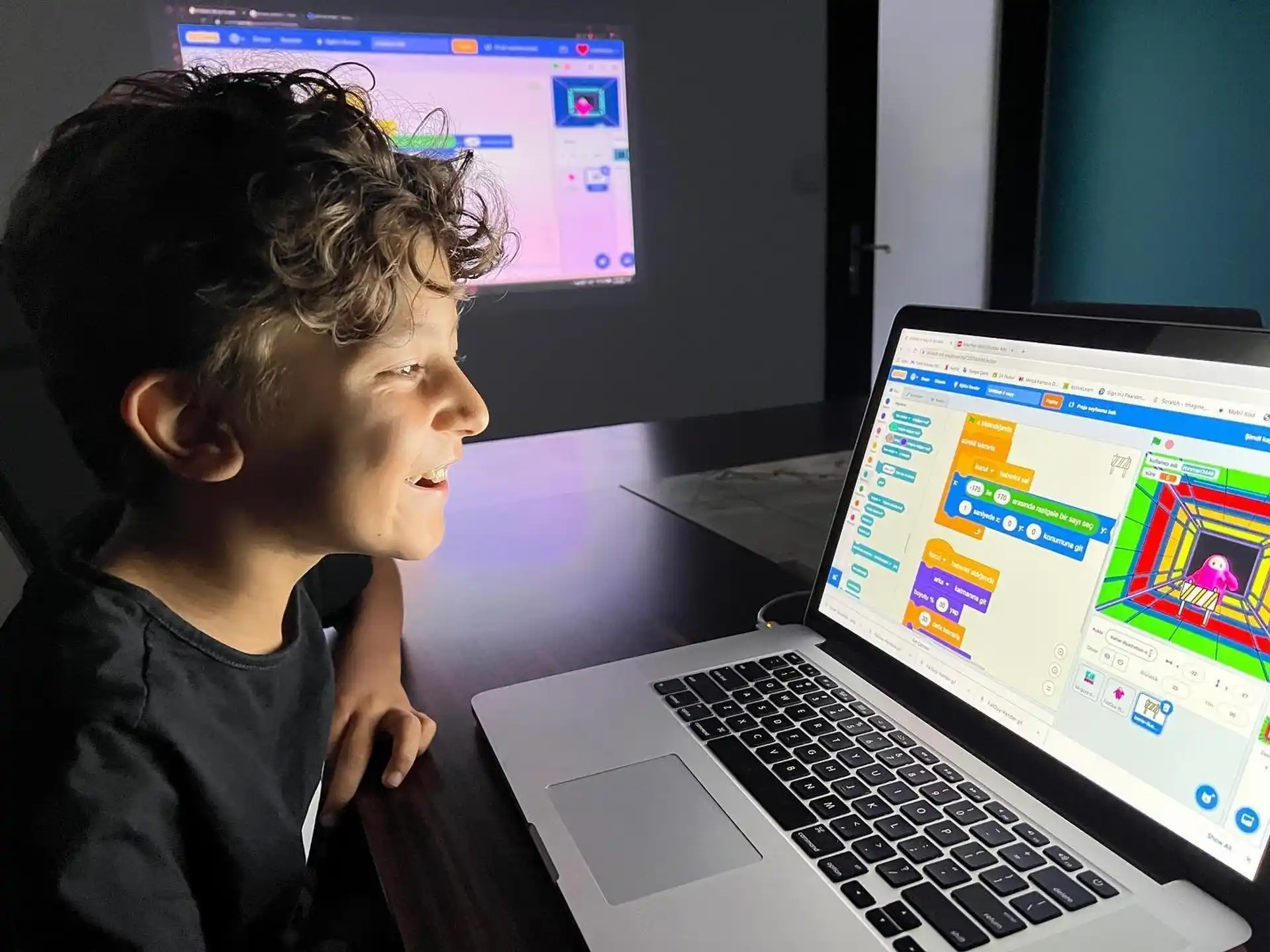 a young boy looking at a laptop
