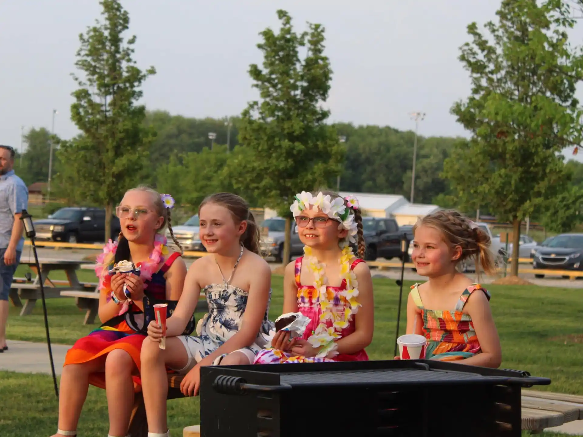 a group of girls sitting on a bench