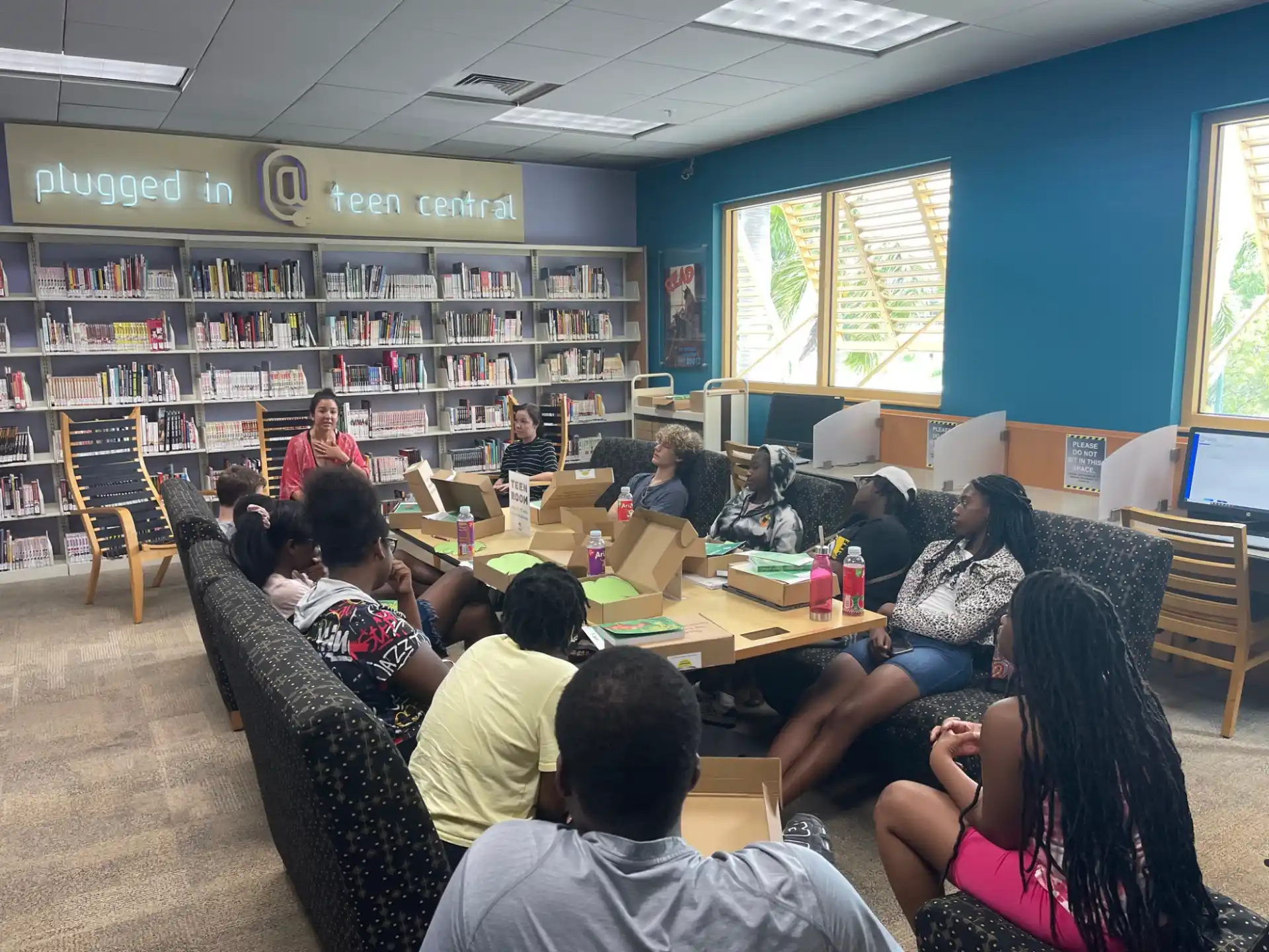 a group of people sitting at a table in a library