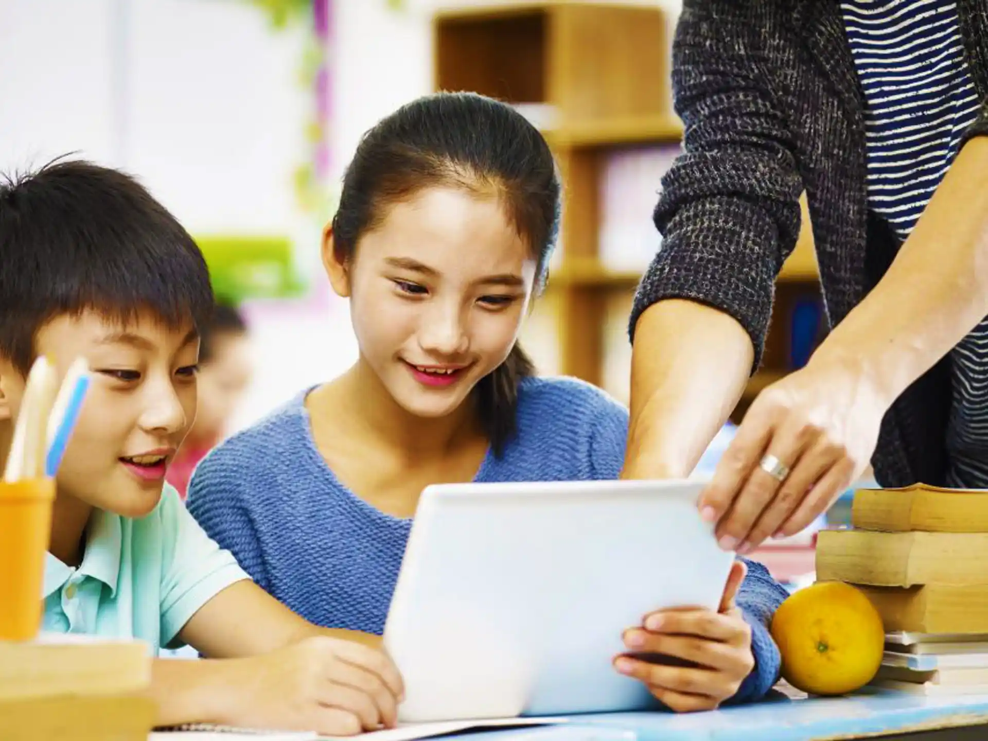 a person and a child looking at a tablet