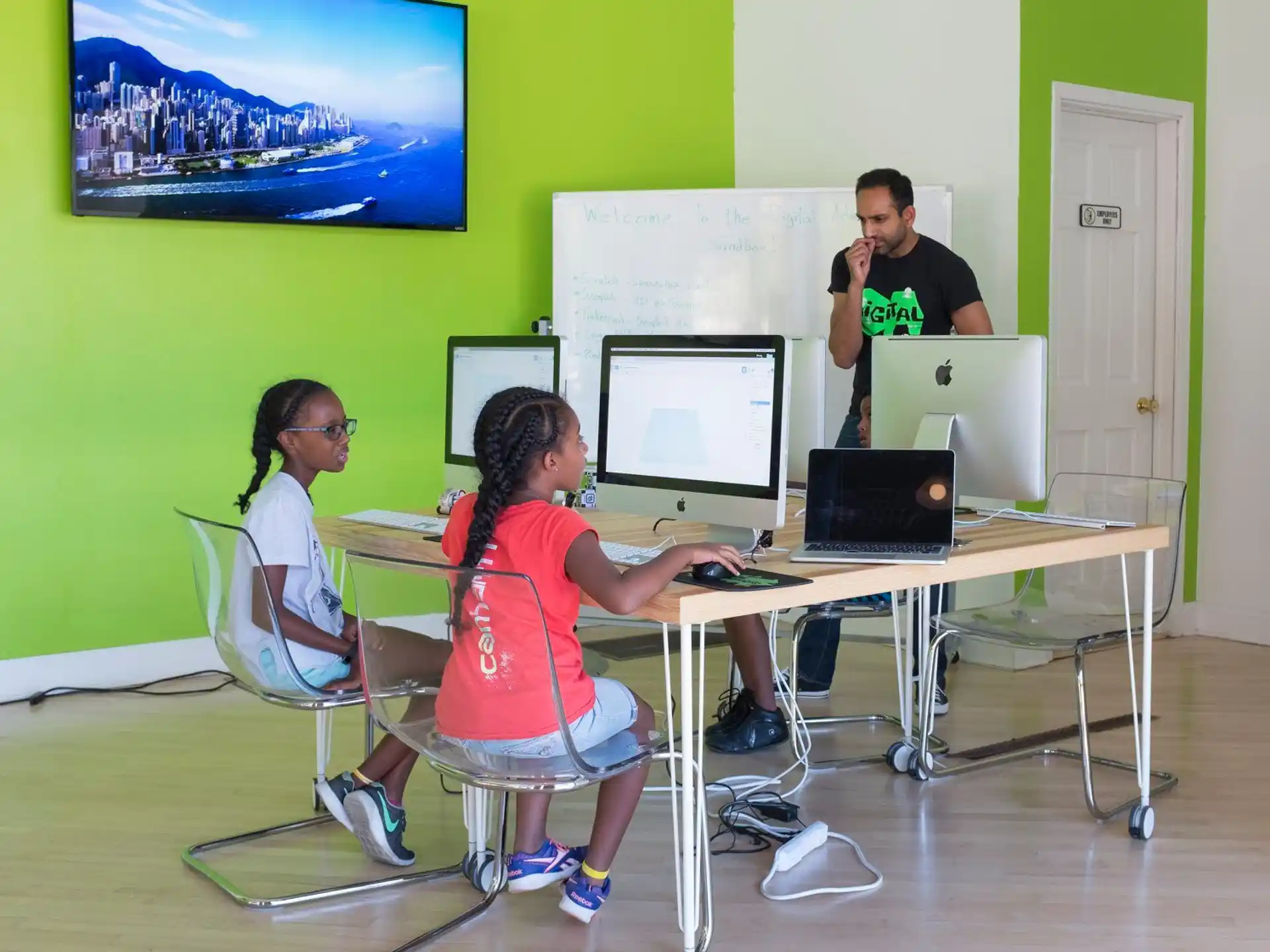 a group of people in a room with computers