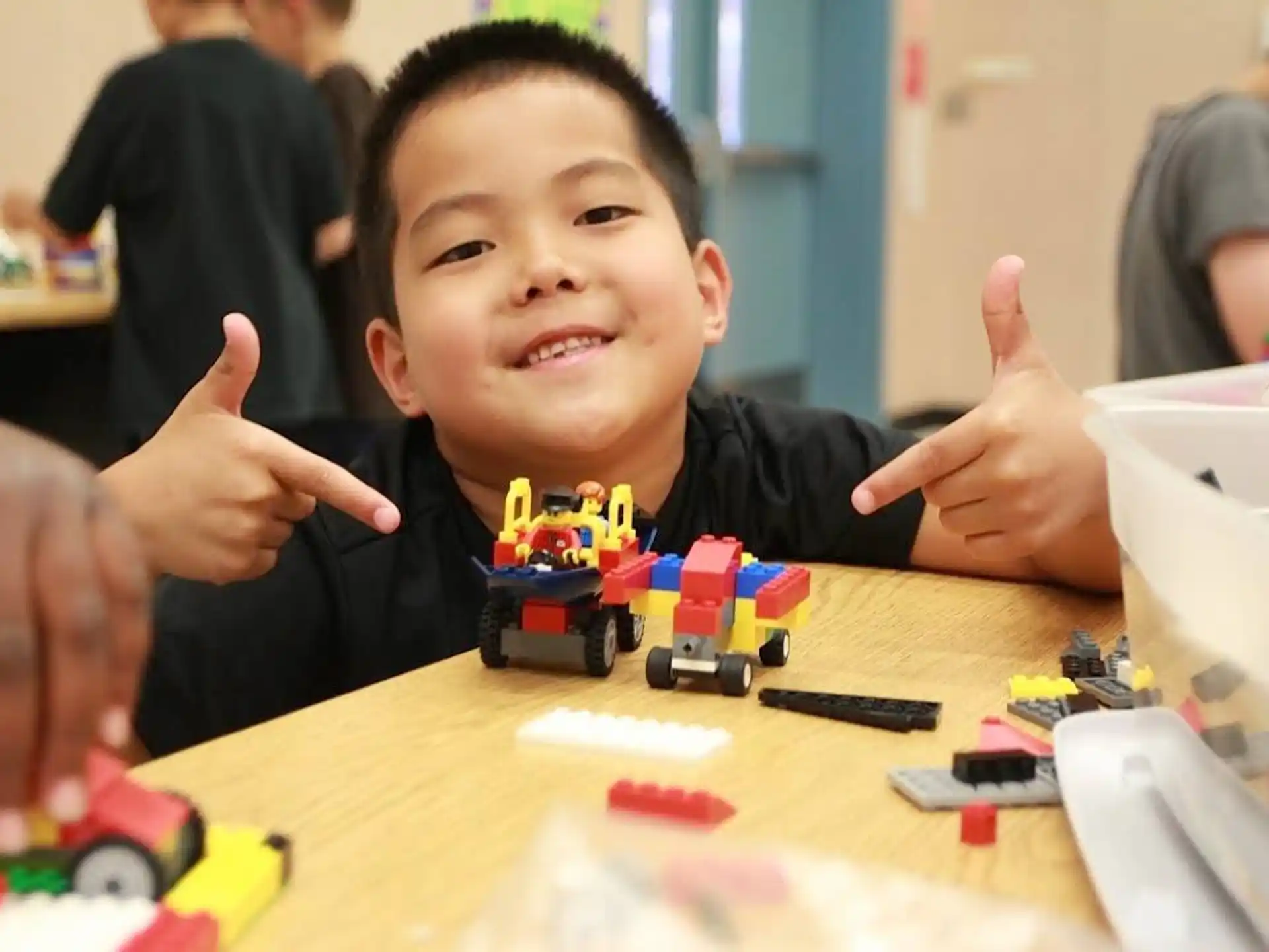 a child making a face with his hands up