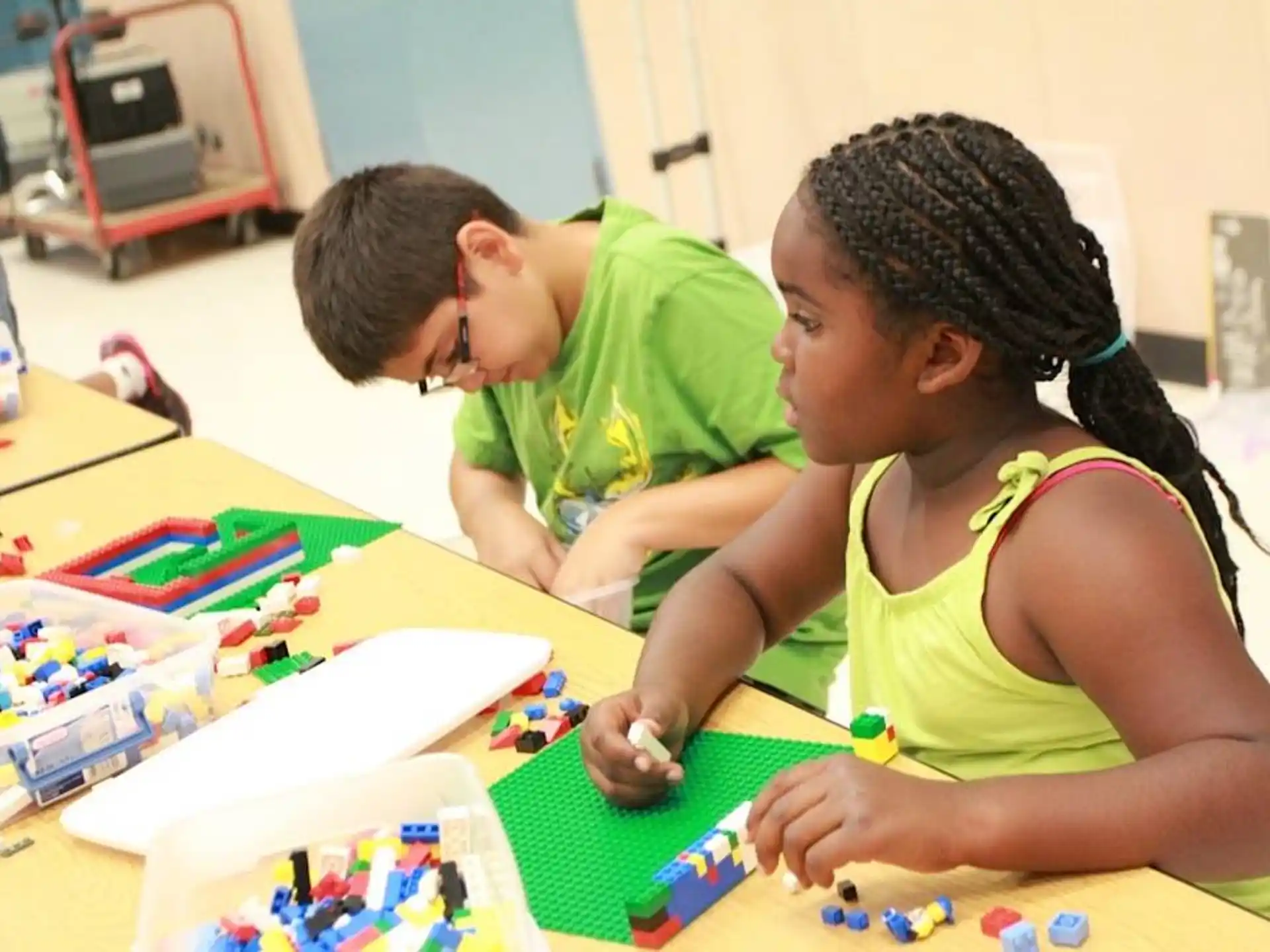 a man and a woman playing with toys on a table