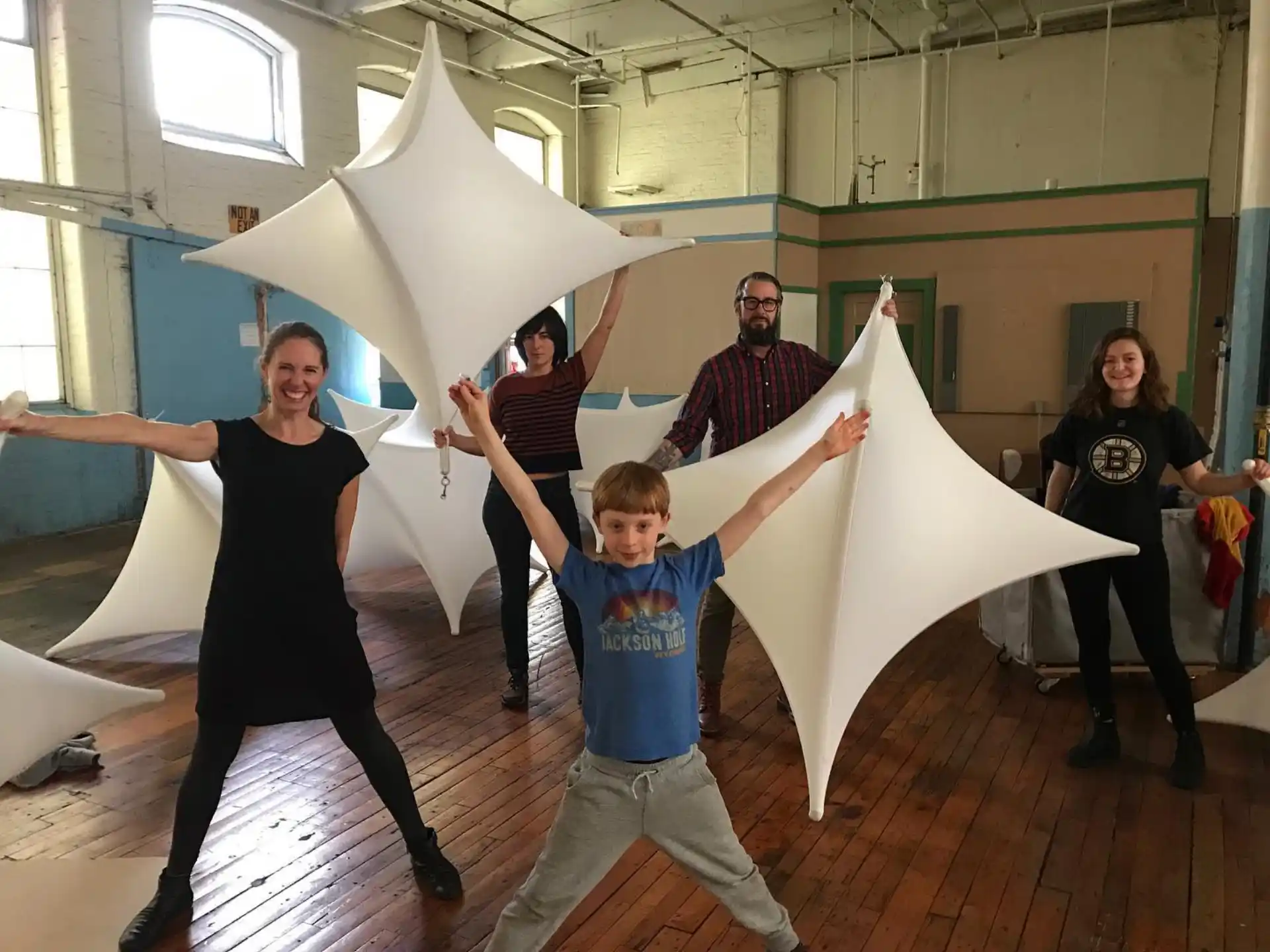 a group of people holding up a white object