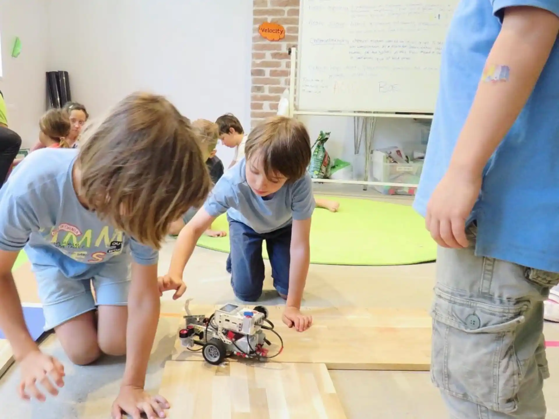 a group of kids playing with a toy truck