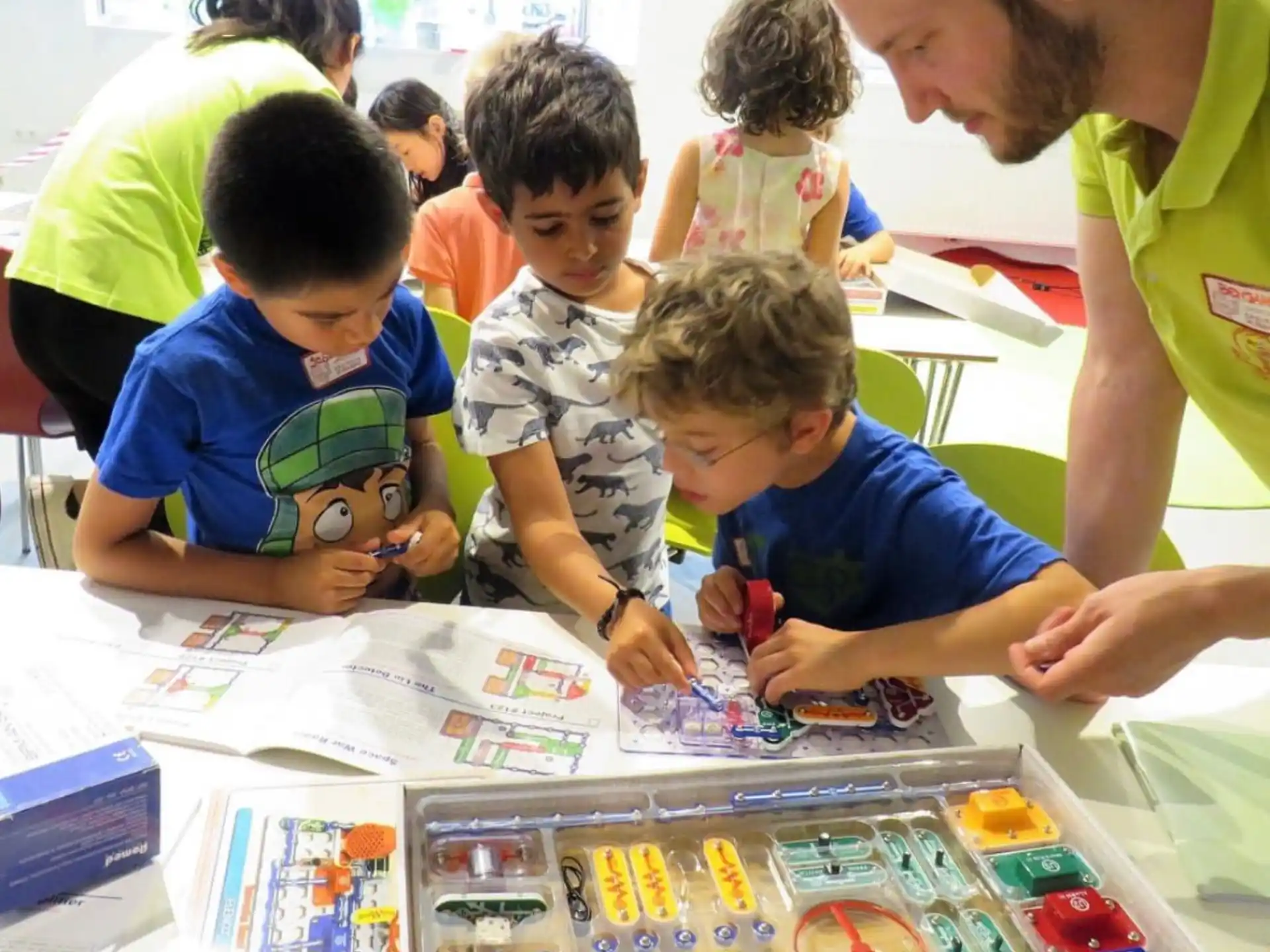a person showing kids something on a paper