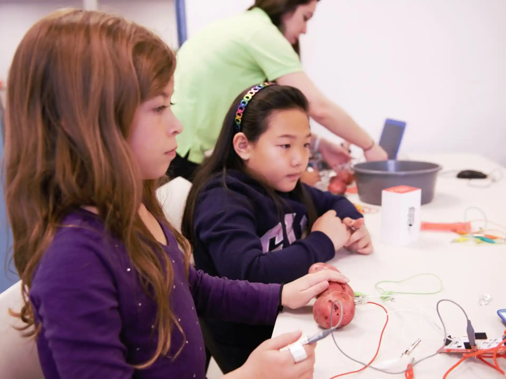 a woman and a girl working on a project