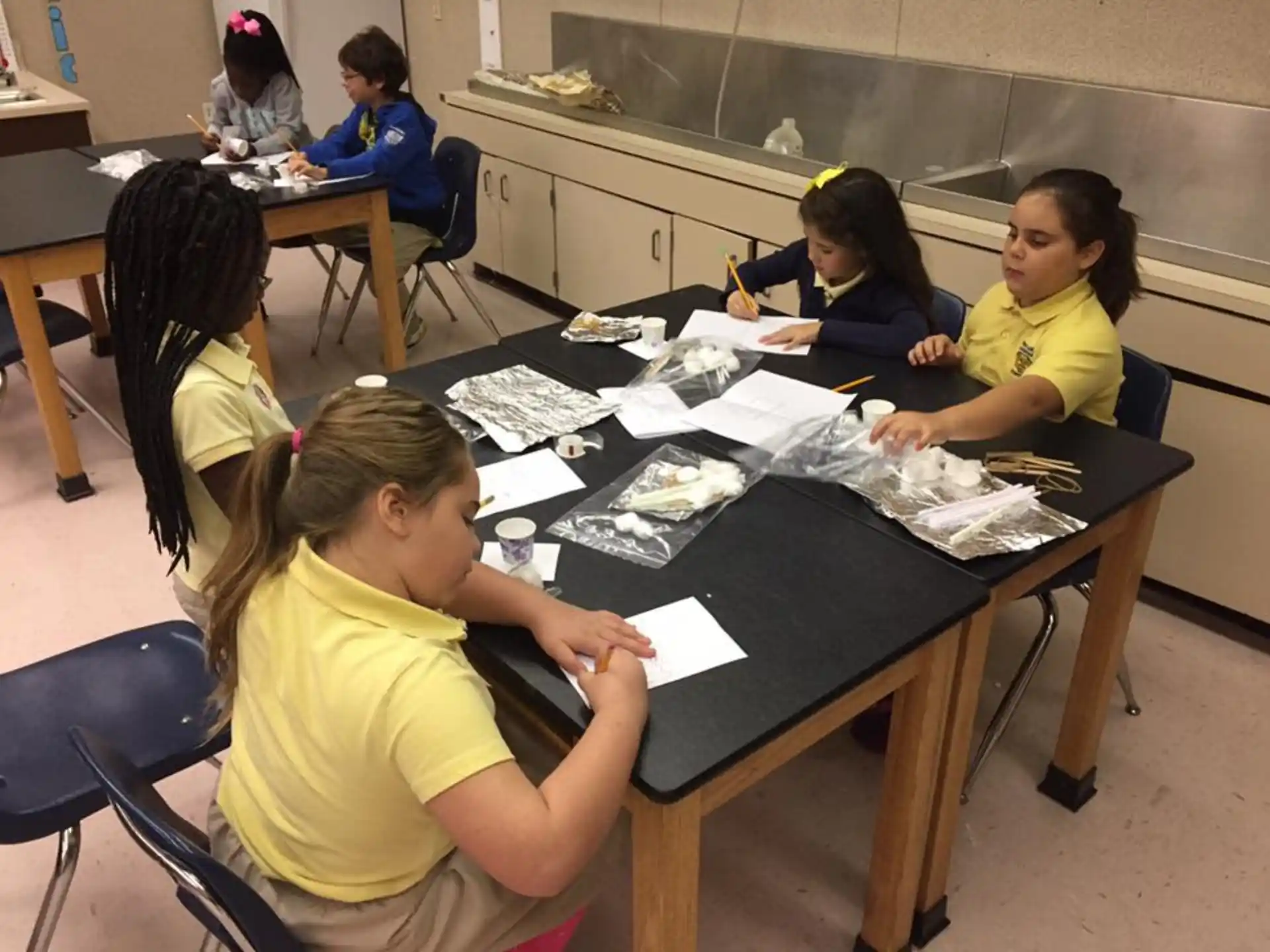 a group of children sitting at a table
