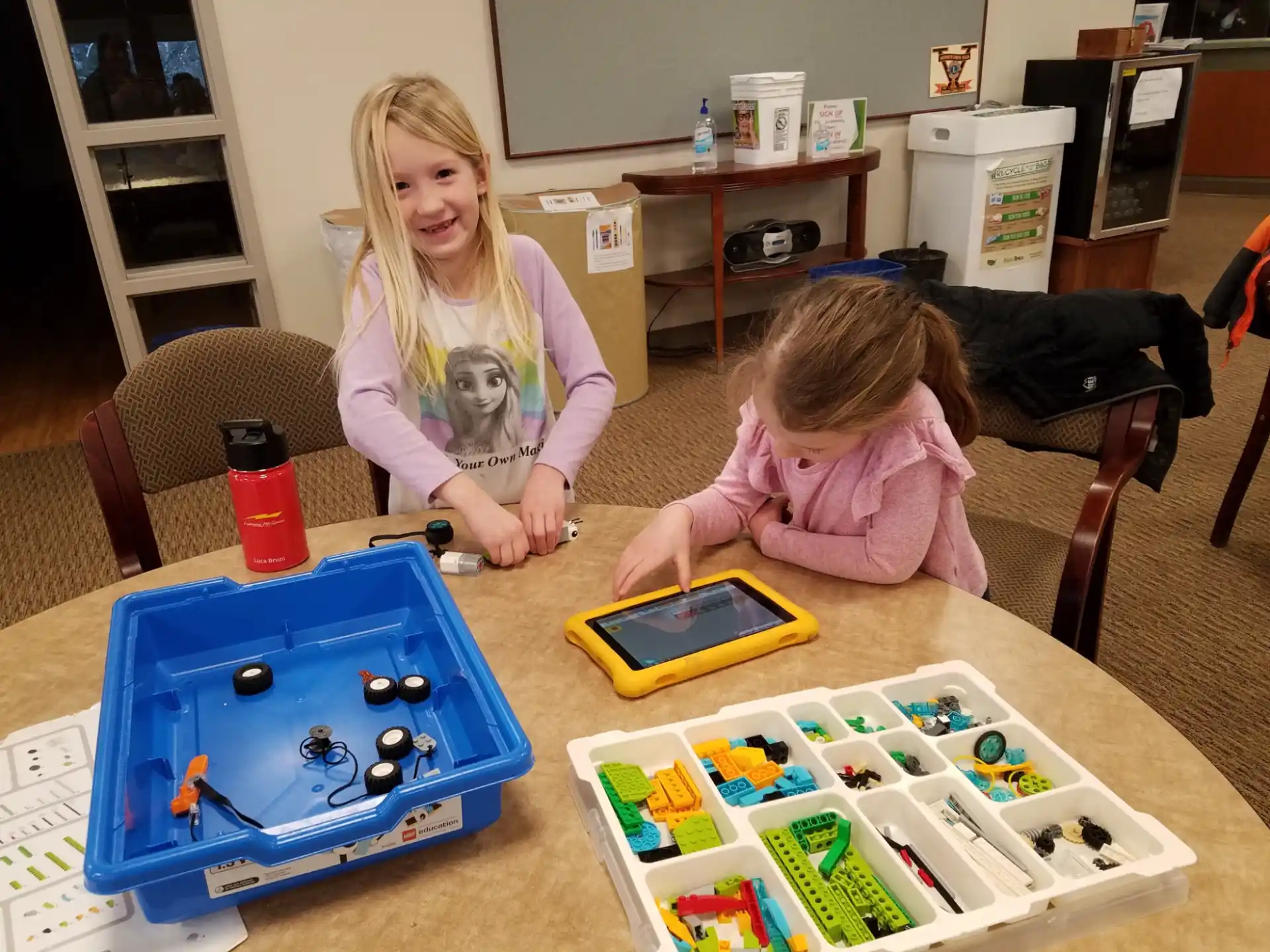 a couple of girls playing with toys