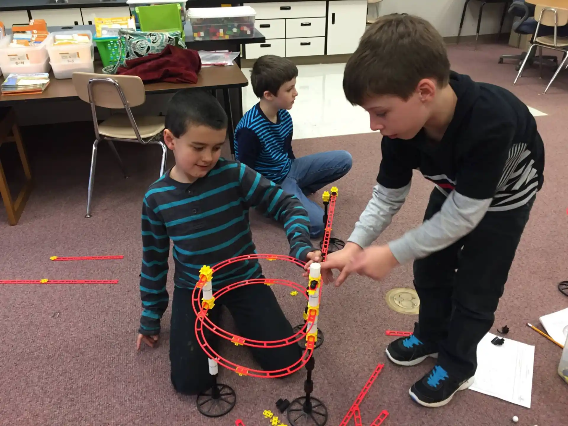 a group of boys playing with a toy