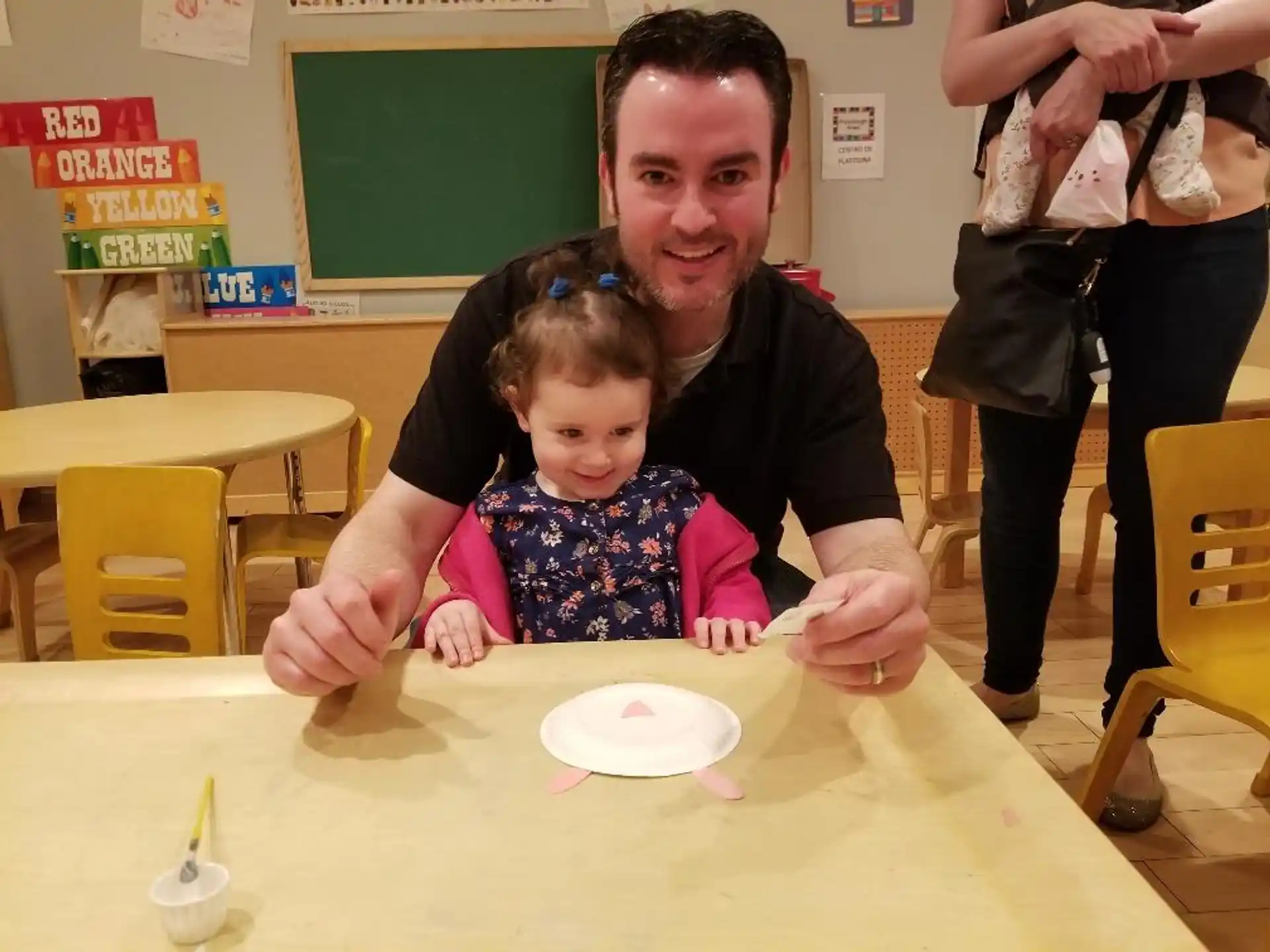 a person and a child sitting at a table
