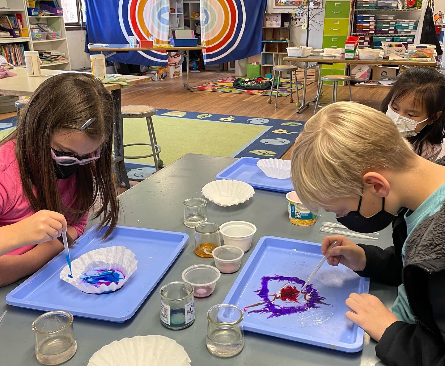 a group of children painting