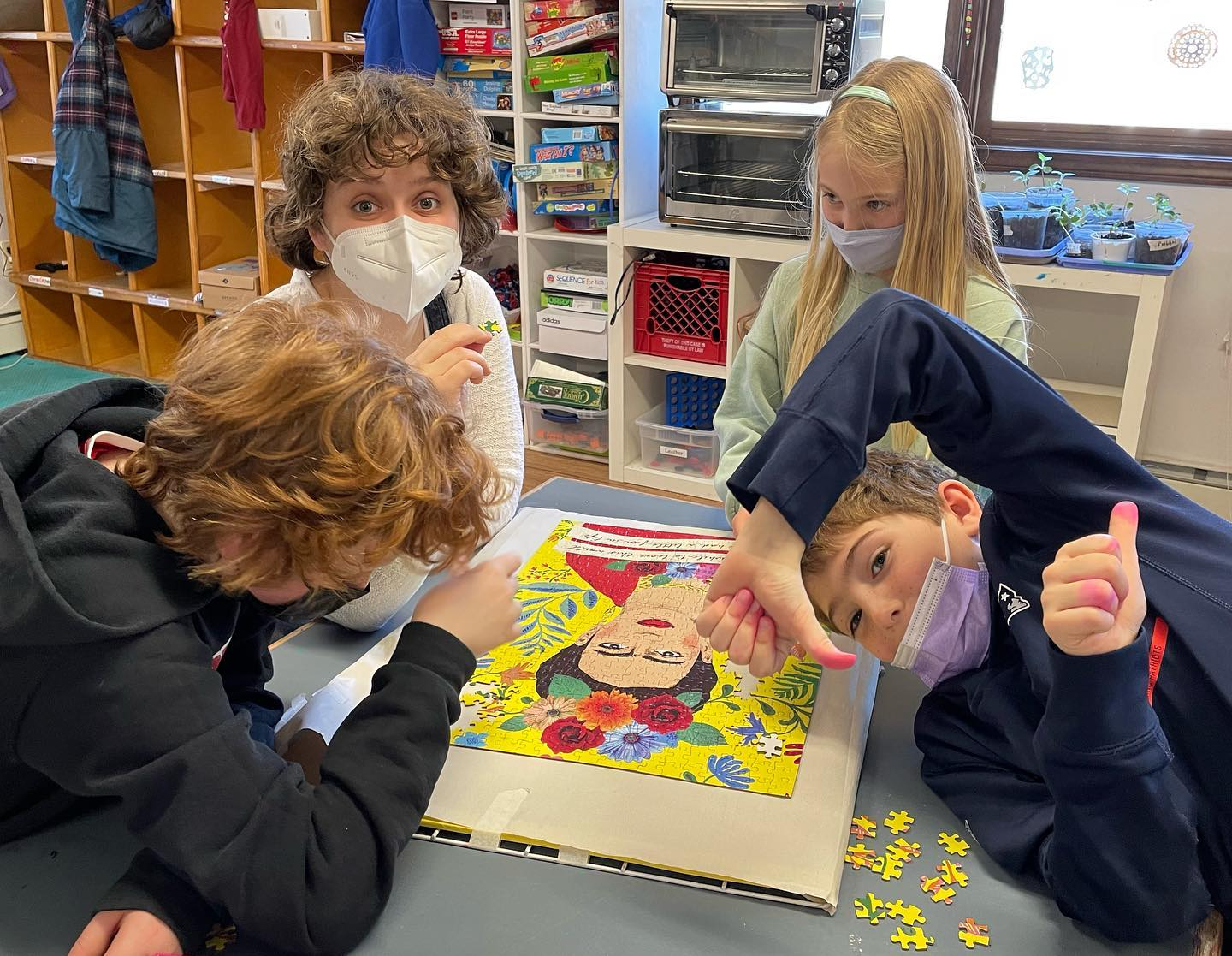 a group of children playing with a puzzle