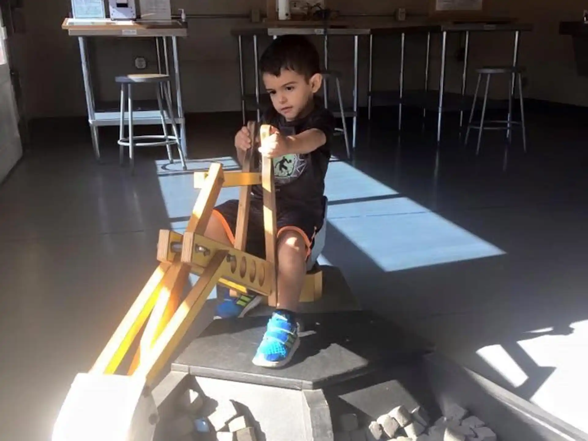 a boy sitting on a model airplane