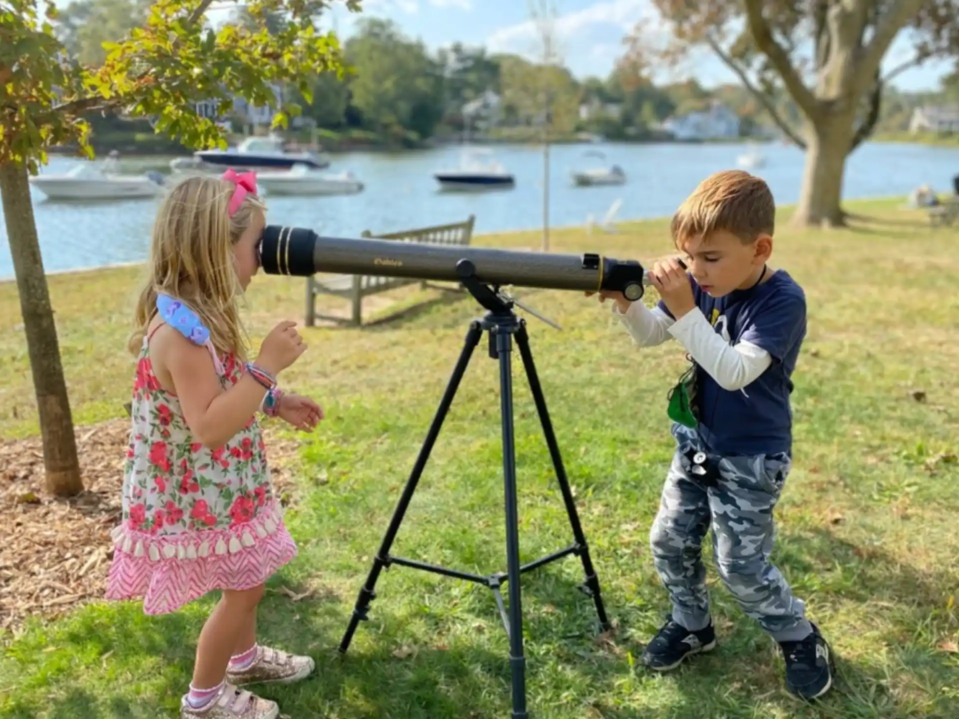 a boy and girl looking at a camera