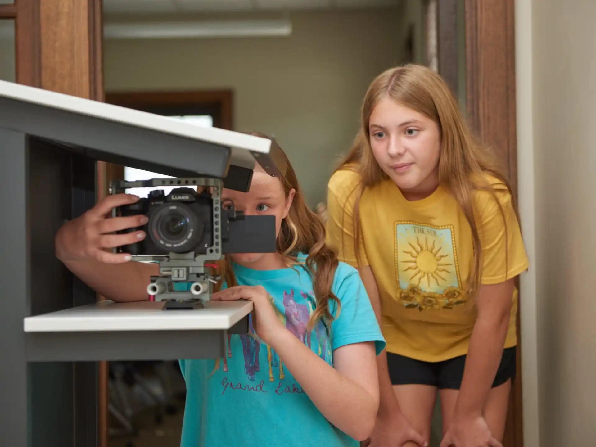 a person taking a picture of another woman holding a camera