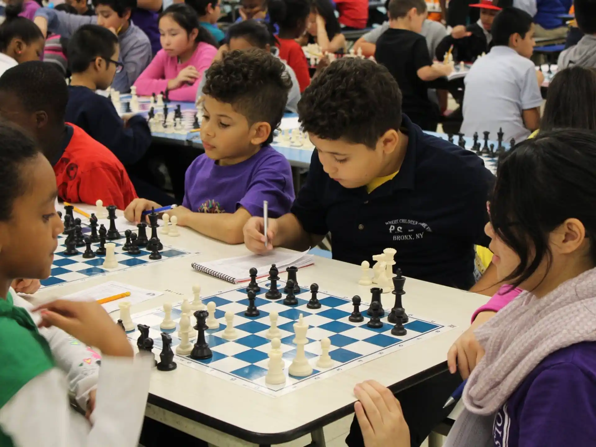 a group of children playing chess