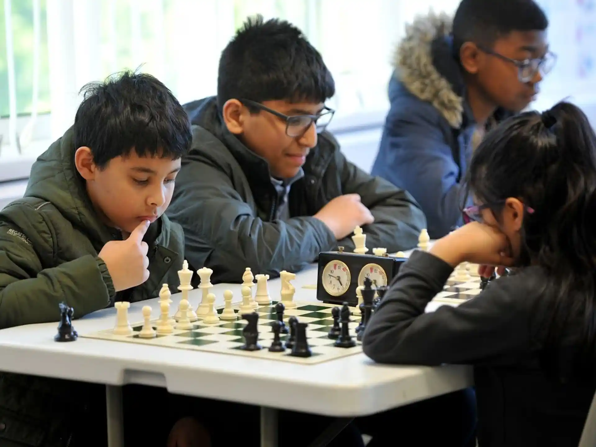 a group of people playing chess